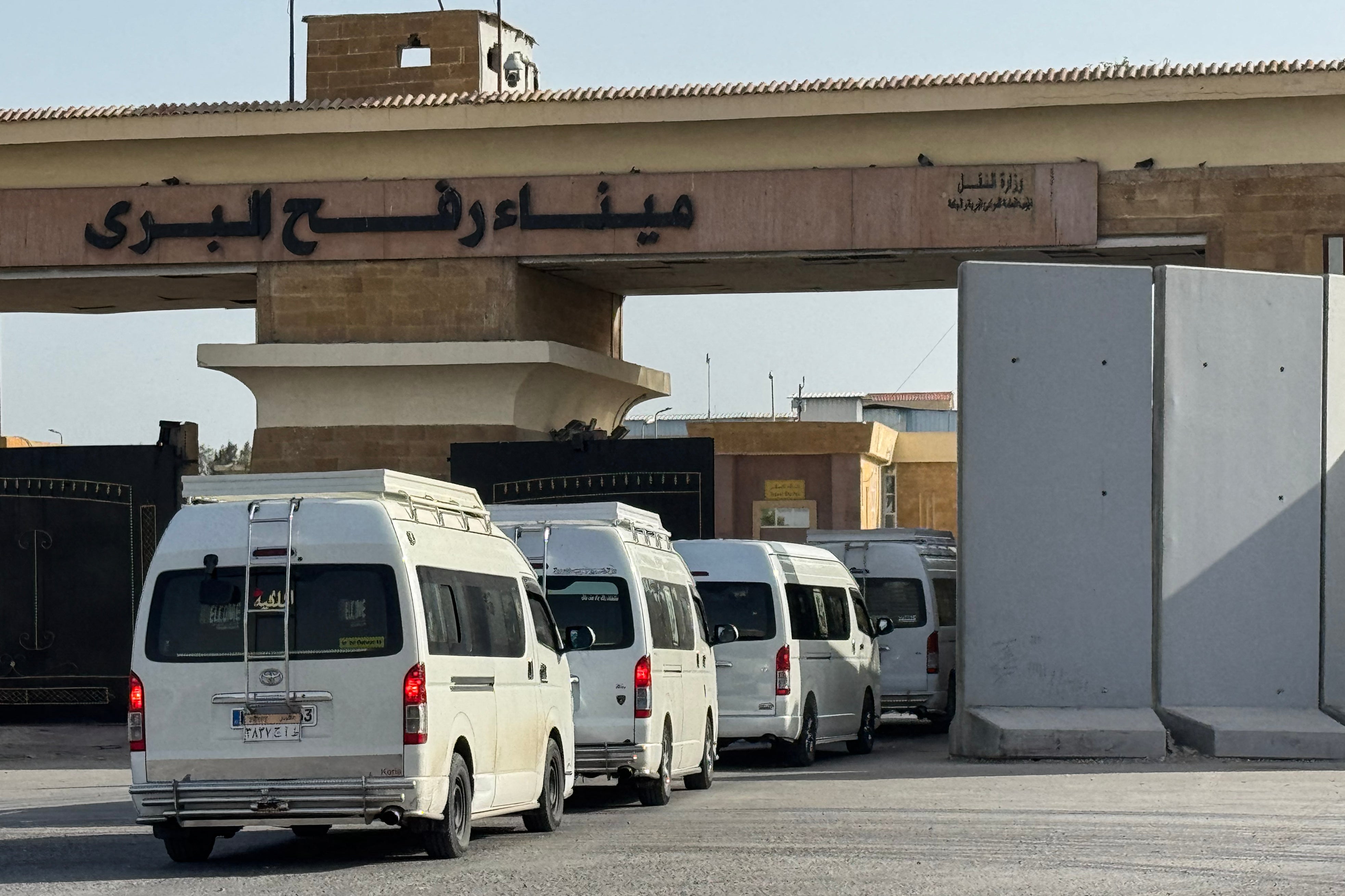 Minibuses carrying Palestinians wishing to return to the Gaza Strip line up on the Egyptian side of the Rafah border crossing on March 19, 2026.