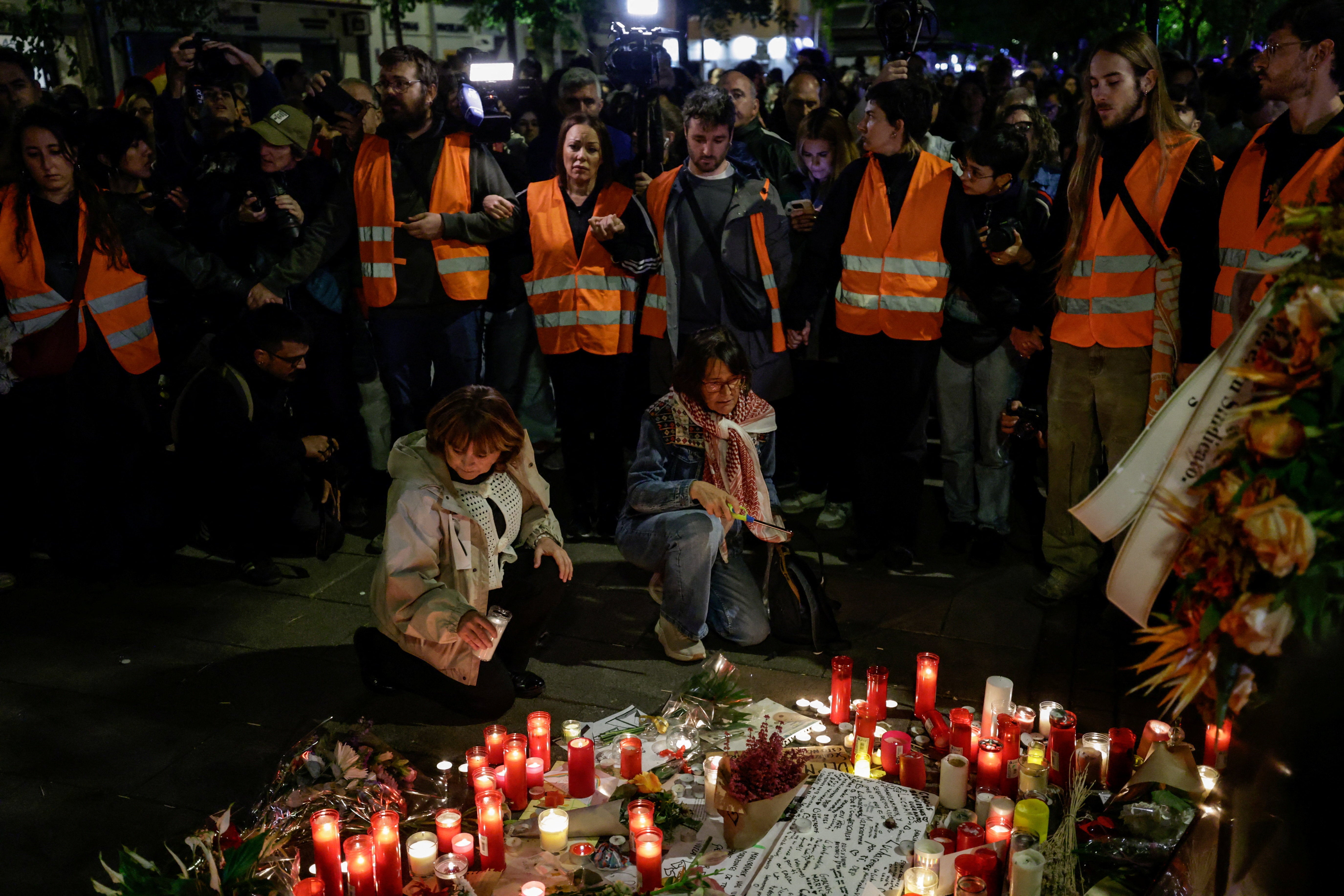 Protesters gather around a makeshift memorial outside the building where Maricarmen Abascal lived