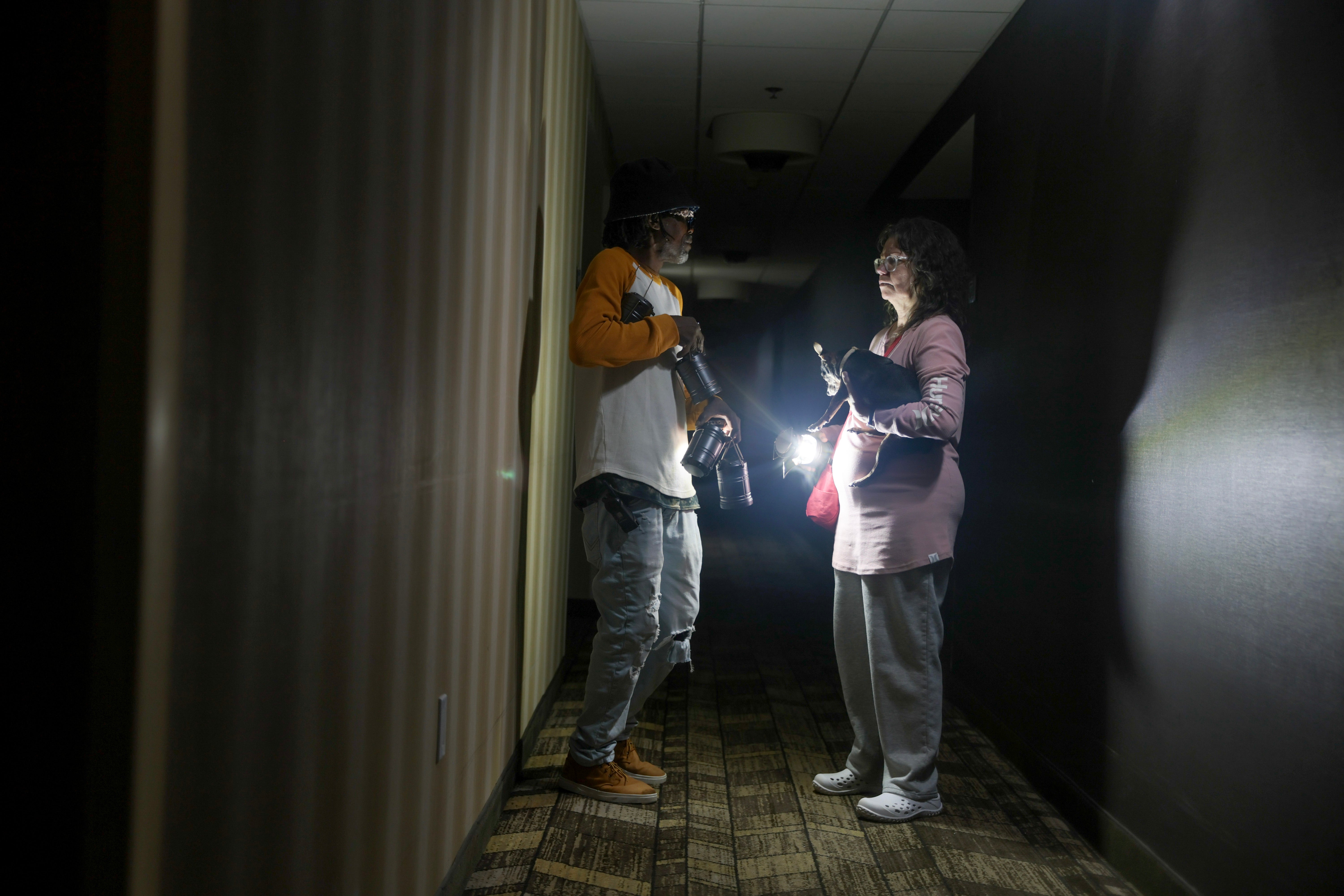 Kevin Hudgins helps guest Laura Gower after a power outage at the Residence Inn