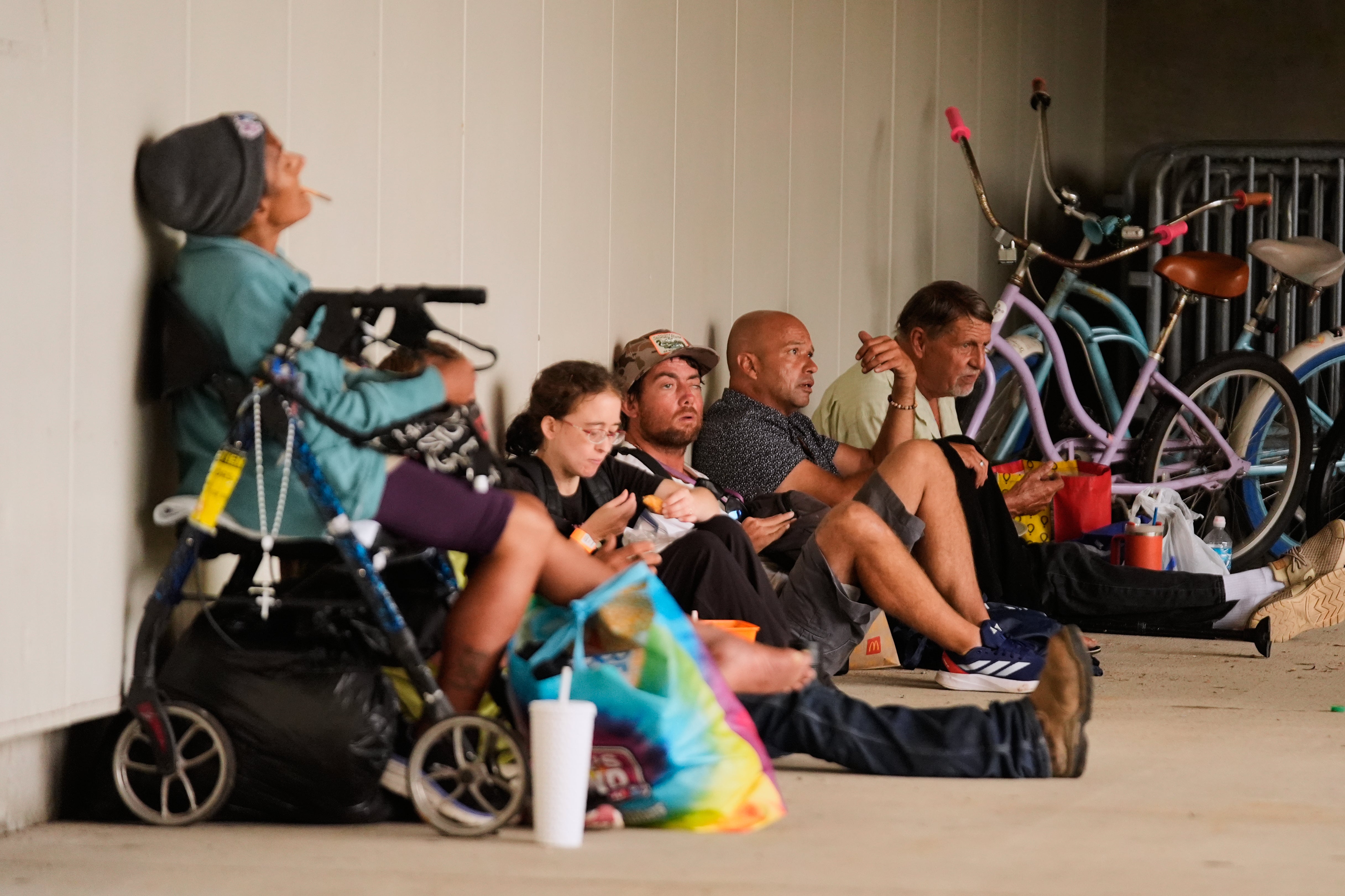 People sit outside an evacuation shelter as Hurricane Isaias approaches Pensacola, Fla., Friday, Oct. 9, 2026