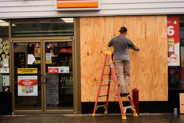 Jason Coffey boards up a convenience store at a gas station as Hurricane Isaias approaches Pensacola Beach, Fla., Friday, Oct. 9, 2026