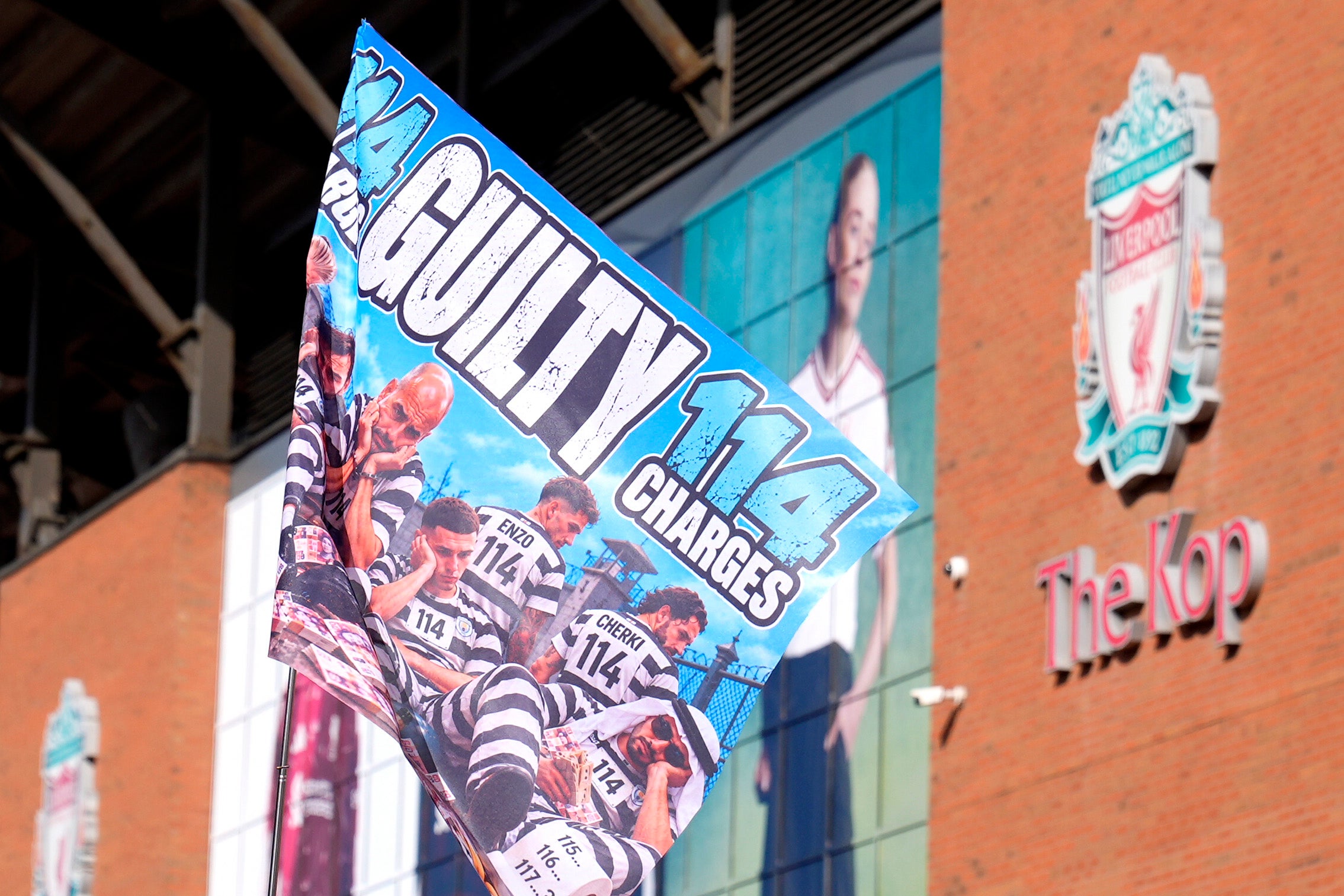 Flags relating to Man City’s charges and verdict were displayed at Anfield