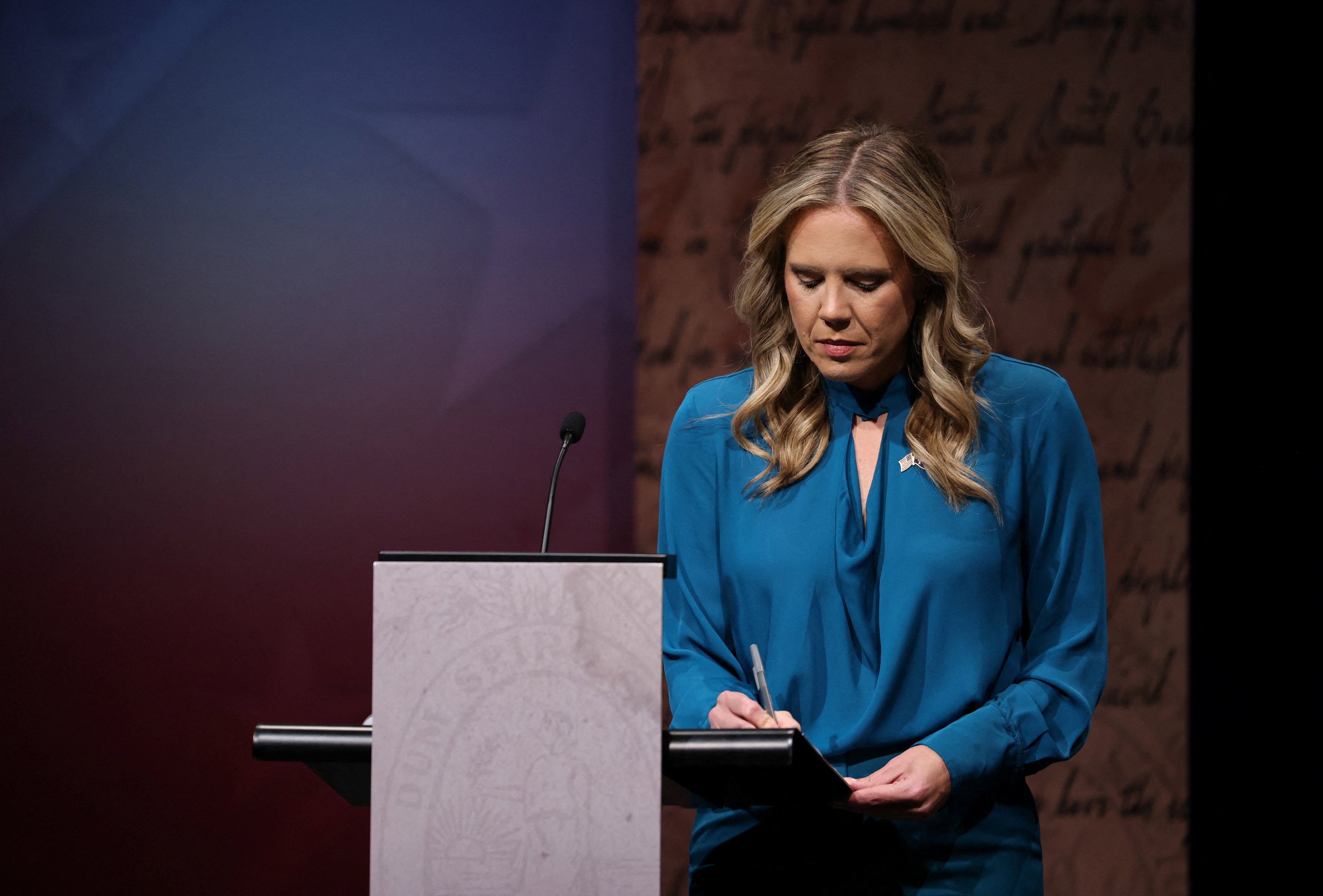Democrat Annie Andrews takes notes before Sunday’s debate with Graham