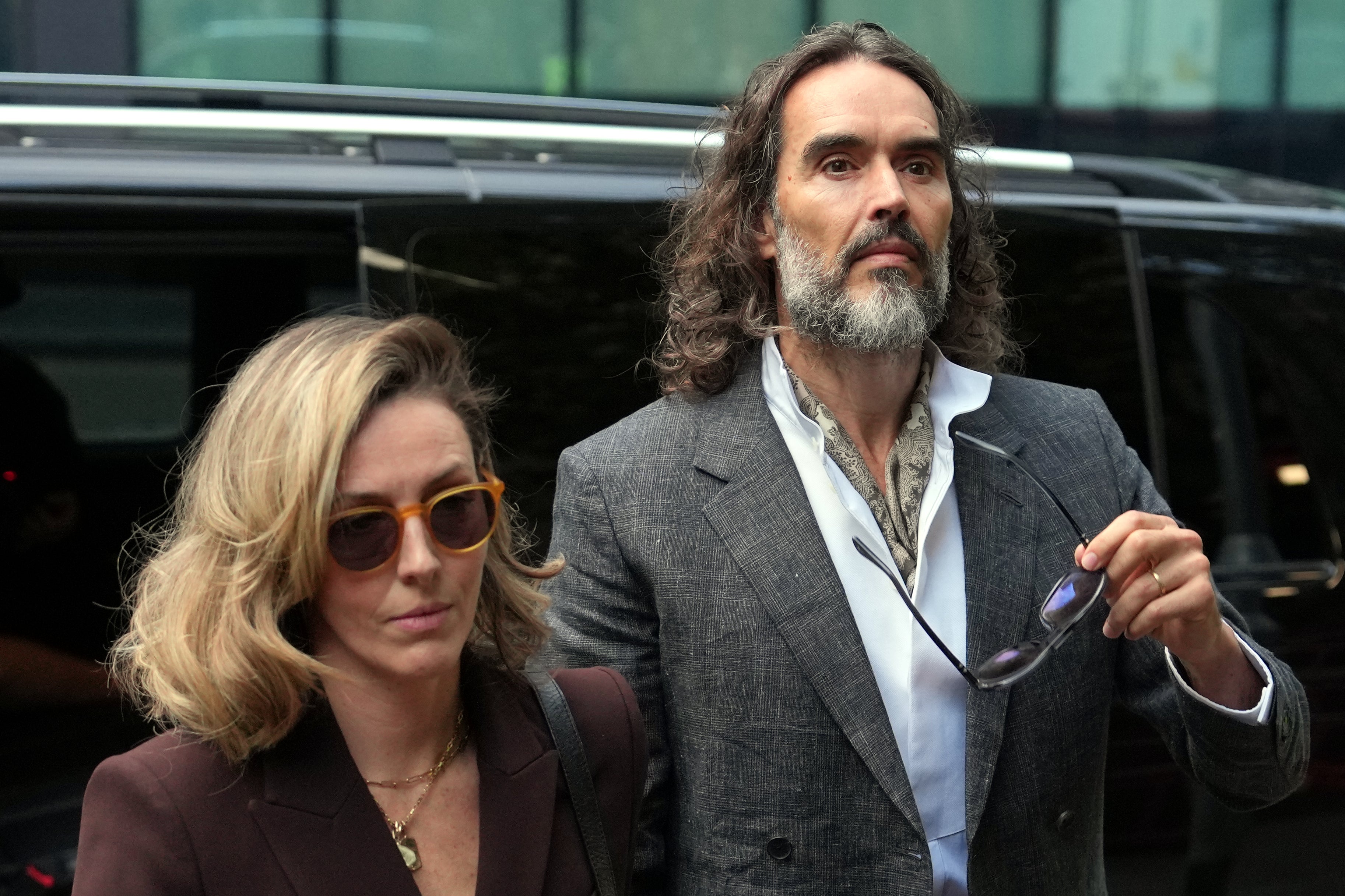Brand pictured arriving with his wife Laura