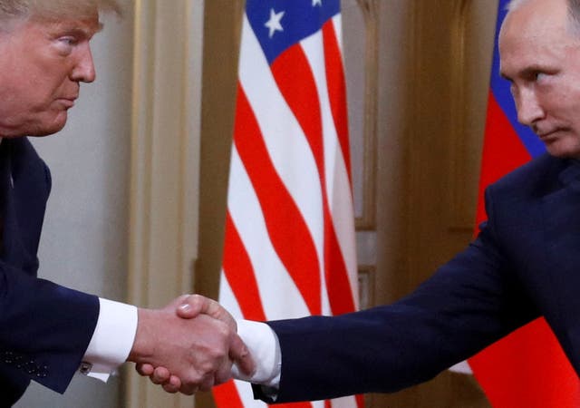 President Donald Trump and Russia's President Vladimir Putin shake hands as they meet in 2018
