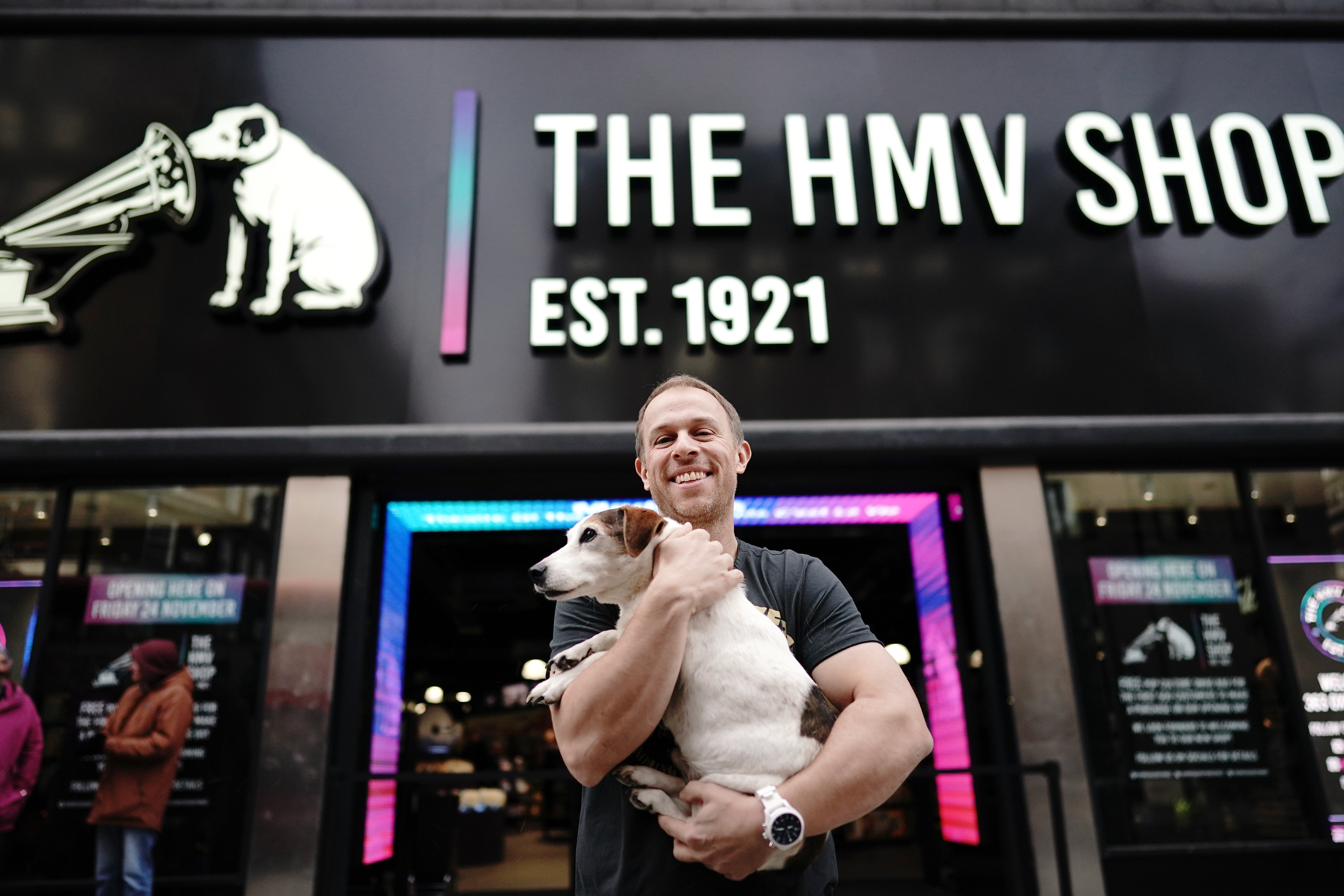 Owner Doug Putman, with dog Holly, outside the HMV store when it returned to Oxford Street (Aaron Chown/PA)