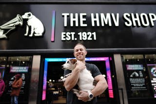 Owner Doug Putman, with dog Holly, outside the HMV store when it returned to Oxford Street (Aaron Chown/PA)