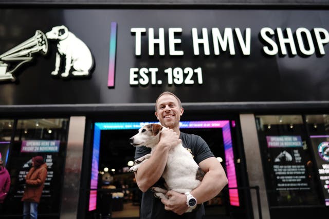 Owner Doug Putman, with dog Holly, outside the HMV store when it returned to Oxford Street (Aaron Chown/PA)