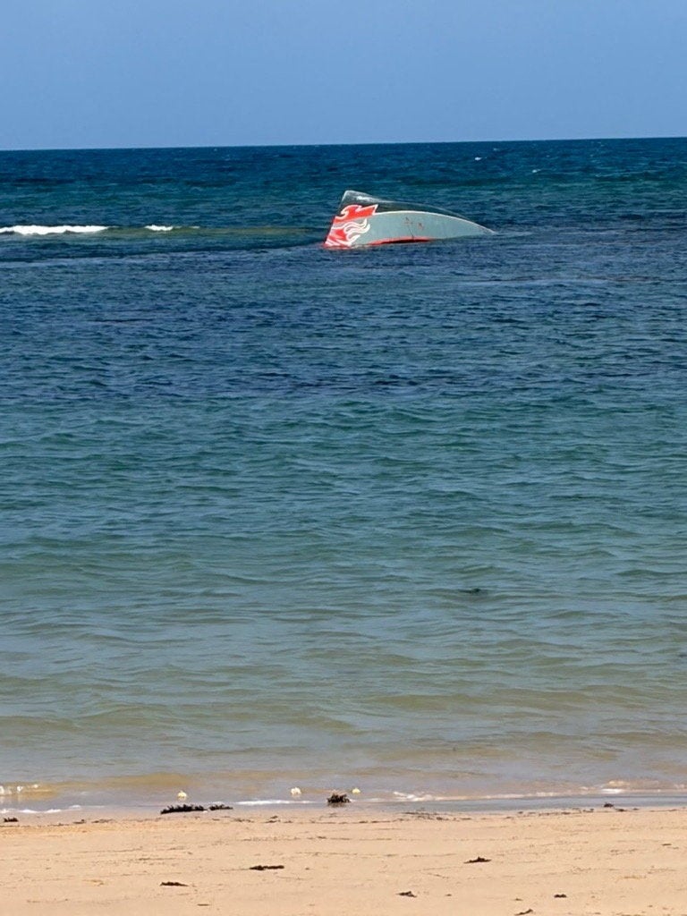 A portion of the vessel floats after it capsized.