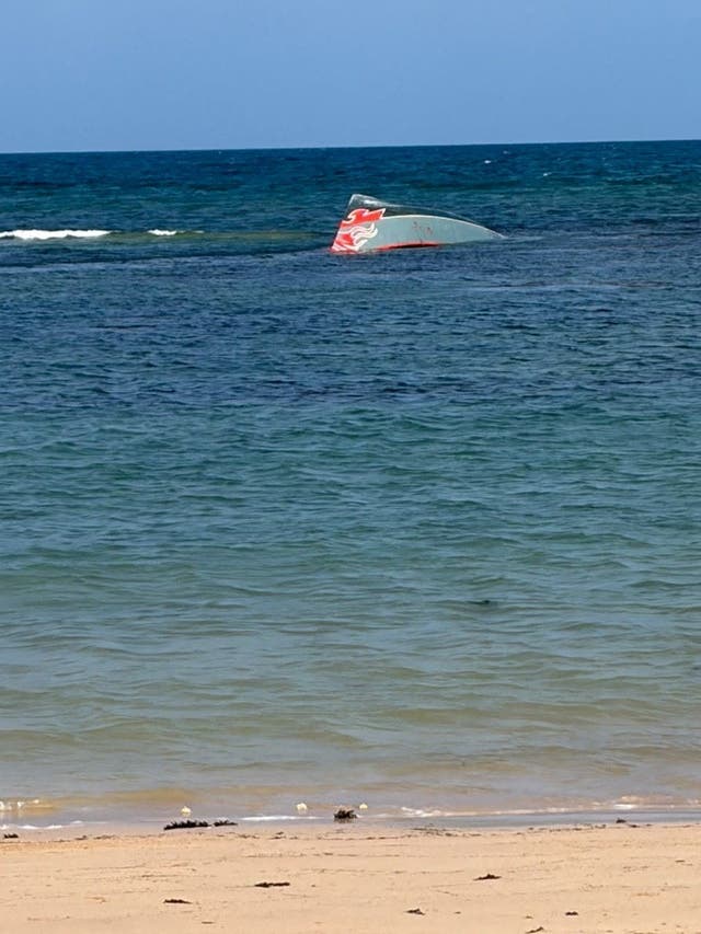 A portion of the vessel floats after it capsized.