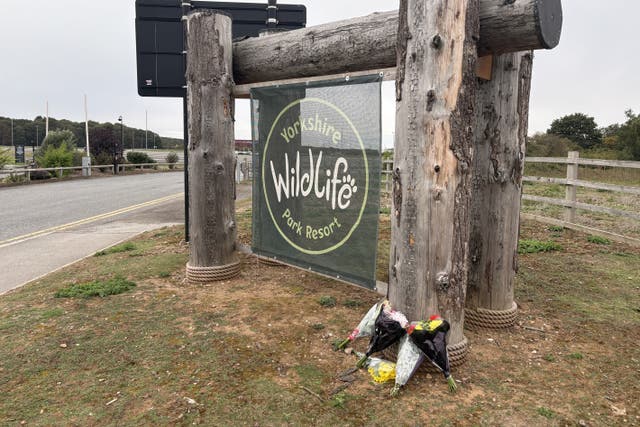 Flowers left at the entrance of Yorkshire Wildlife Park in Doncaster, where a man died after suffering serious injuries in a tiger enclosure at the wildlife park (Dave Higgens/PA)