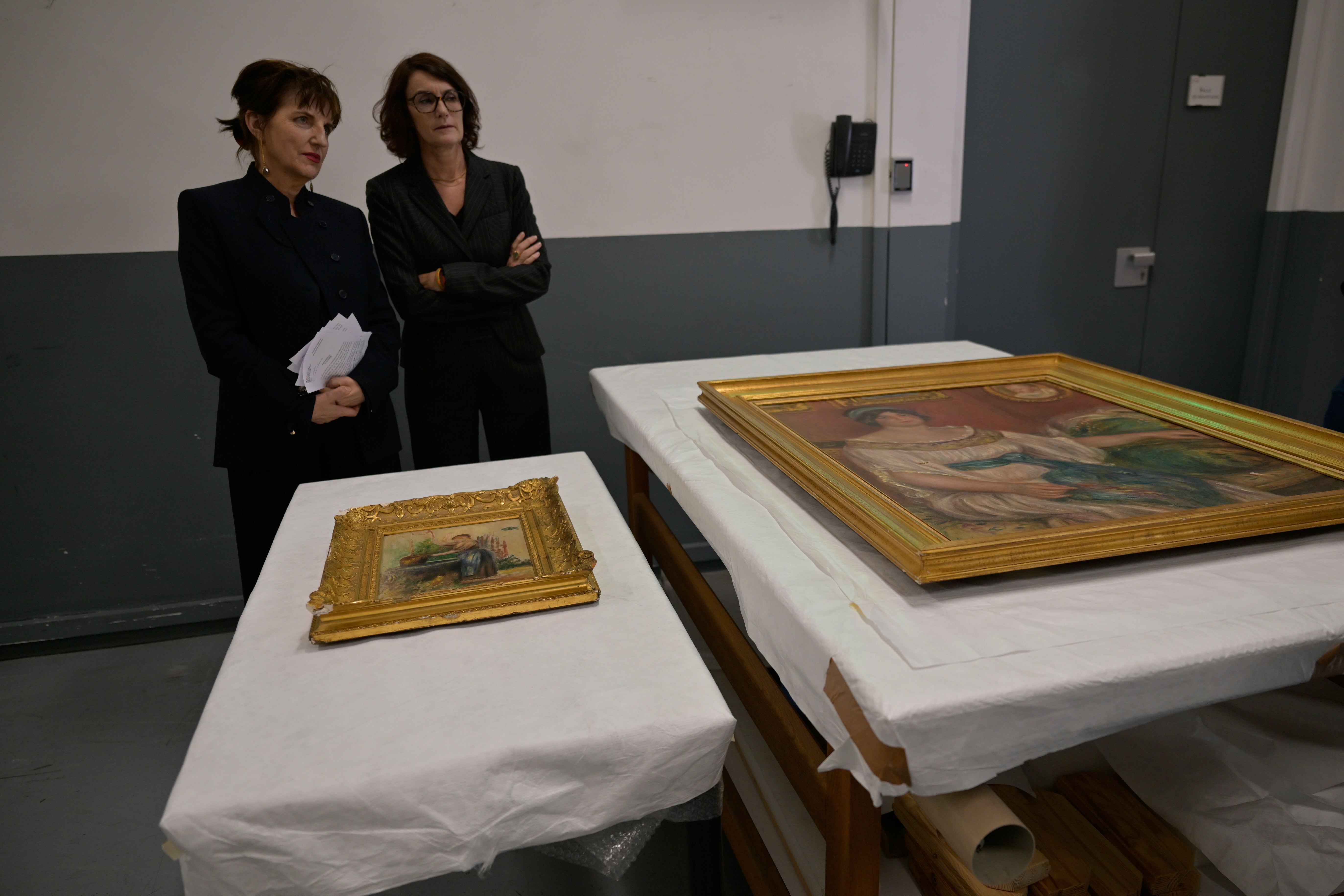 Recovered paintings "Portrait of Madame Colonna Romano" right, and "Young Woman at the Well," stolen from the Renoir Museum in Cagnes-sur-Mer are on display at the Interdisciplinary Centre for the Conservation and Restoration of Heritage in Marseille, France, Monday Oct. 12, 2026. (AP Photo/Philippe Magoni)