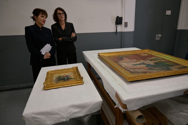 Recovered paintings "Portrait of Madame Colonna Romano" right, and "Young Woman at the Well," stolen from the Renoir Museum in Cagnes-sur-Mer are on display at the Interdisciplinary Centre for the Conservation and Restoration of Heritage in Marseille, France, Monday Oct. 12, 2026. (AP Photo/Philippe Magoni)