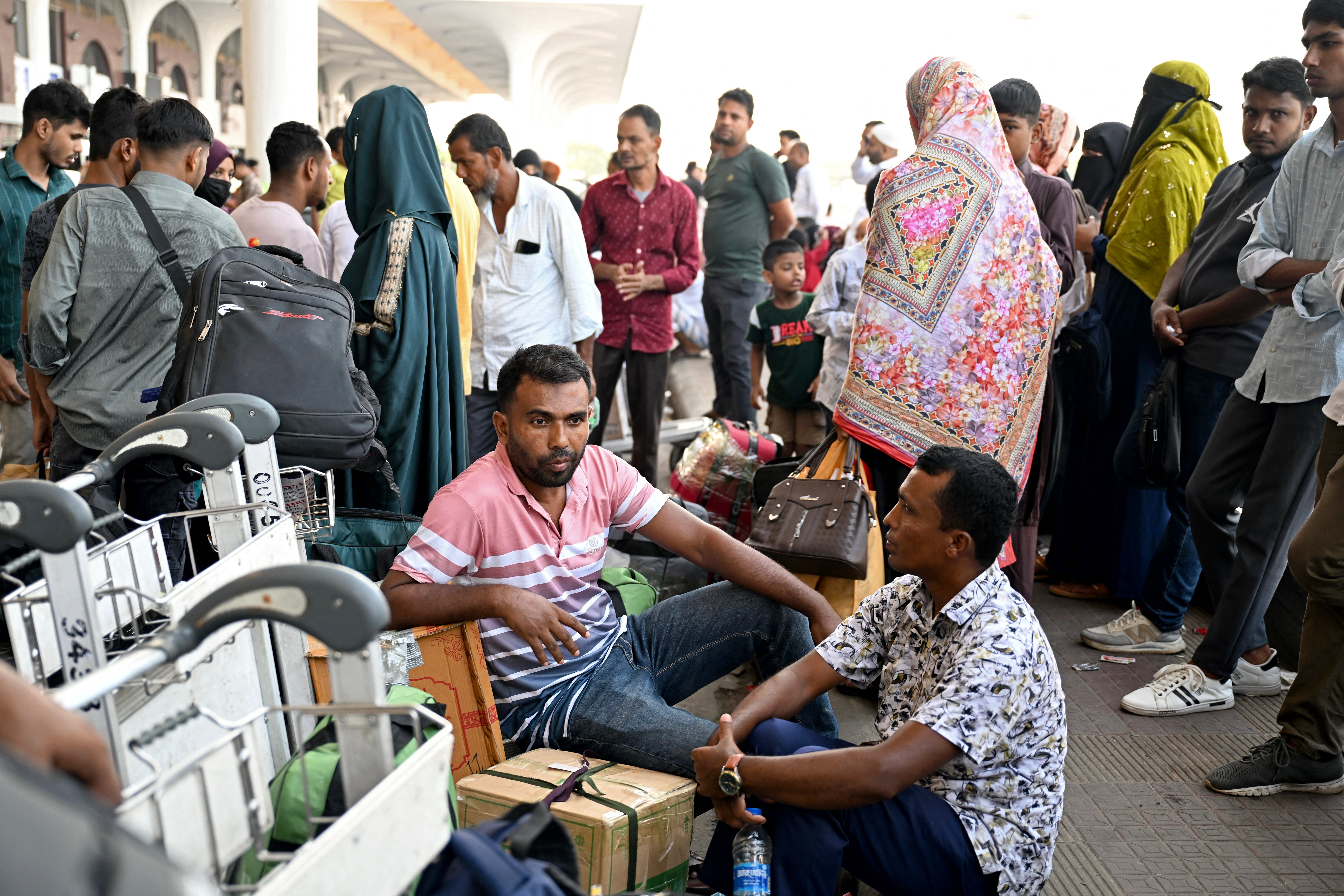 Saudi Arabia-bound passengers remain stranded at the Hazrat Shahjalal International Airport in Dhaka on October 12, 2026, after their flights were cancelled a day after a Houthi strike at Riyadh's international airport.