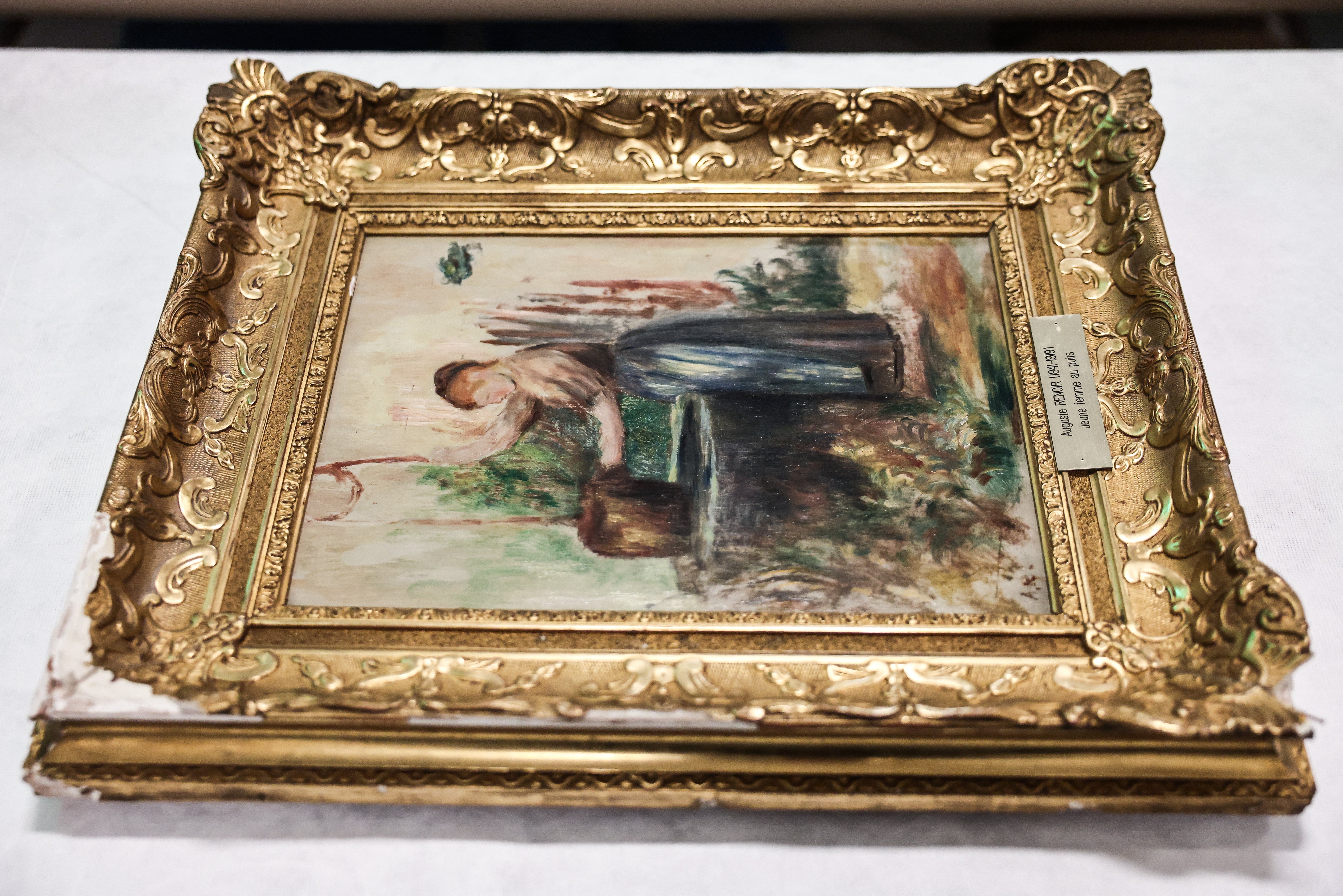 This photograph shows the "Femme au puits" (Young Woman at the Well) painting by French impressionist painter Pierre-Auguste Renoir, that were stolen from the Renoir Museum in Cagnes-sur-Mer, southern France, presented to the press on October 12, 2026