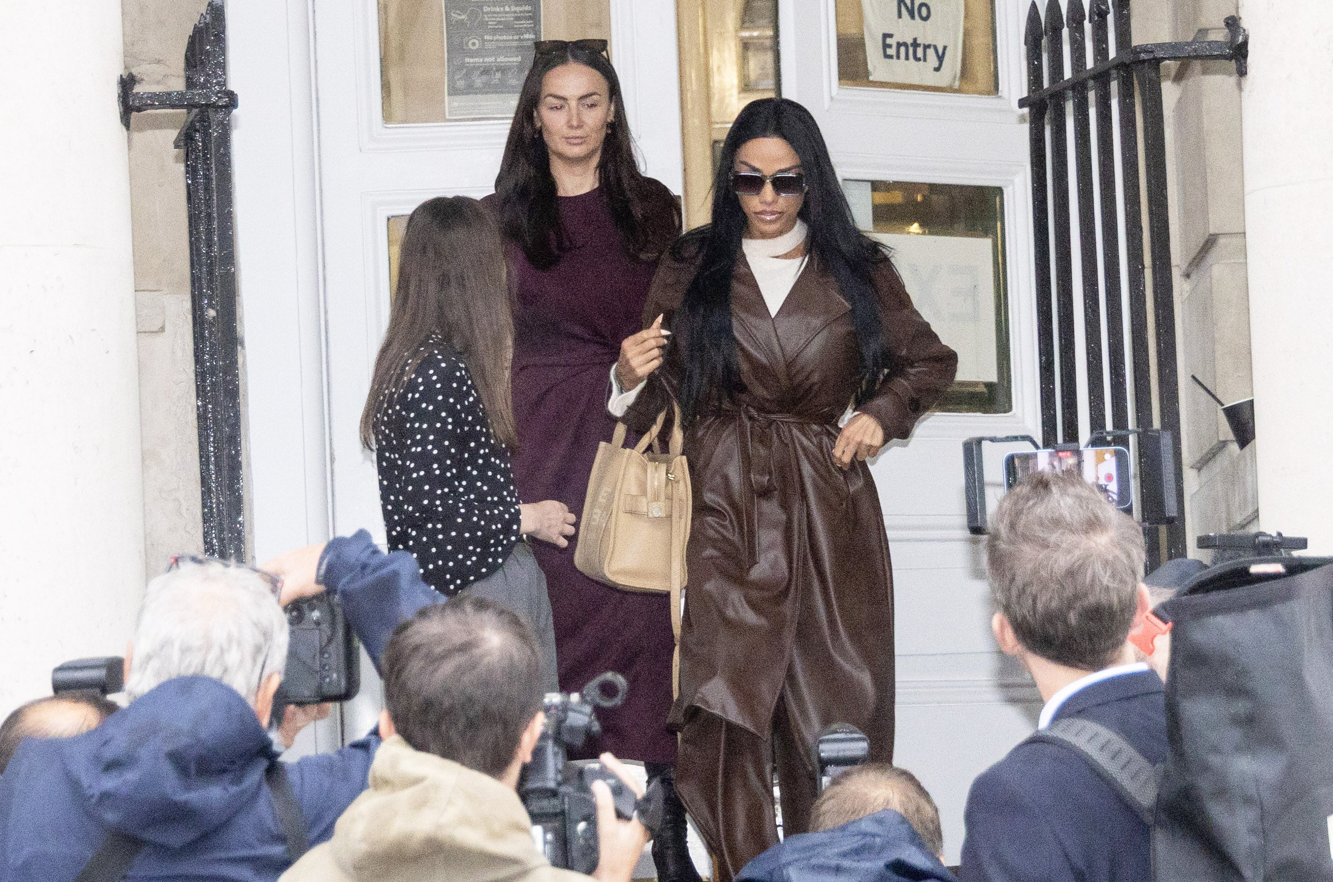 Katie Price (right) leaves after giving evidence at Lewes Crown Court