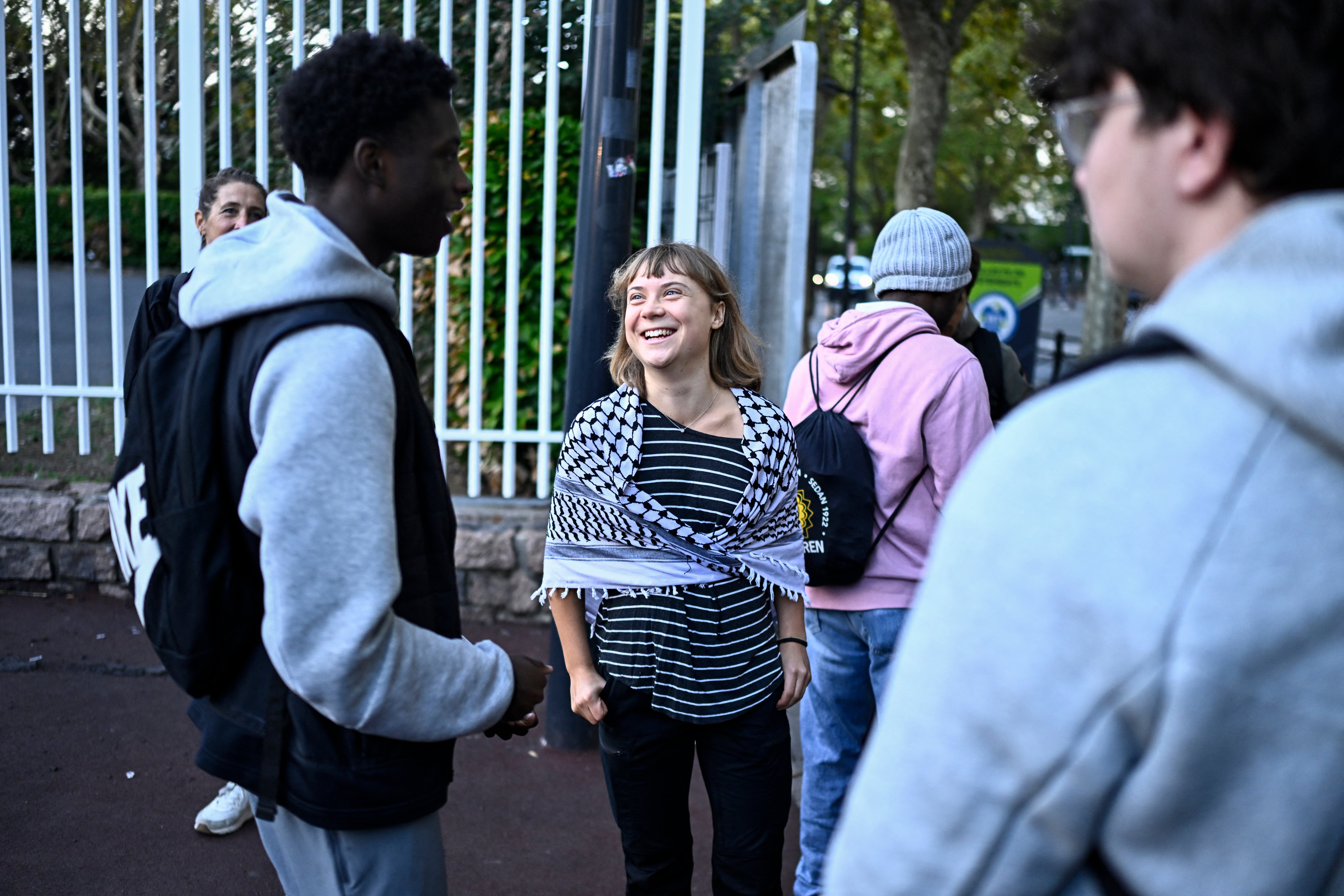 Swedish activist Greta Thunberg speaks with students as they prepare to take part in a blockade at the Lycee Paul Eluard in Saint-Denis, on the outskirts of Paris on October 13, 2026