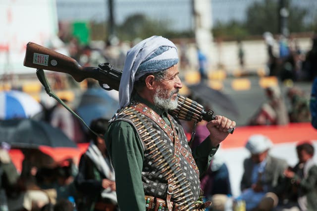 A supporter of Yemen's Houthi rebels carries his rifle during a rally in support of the group, in Sanaa, Yemen