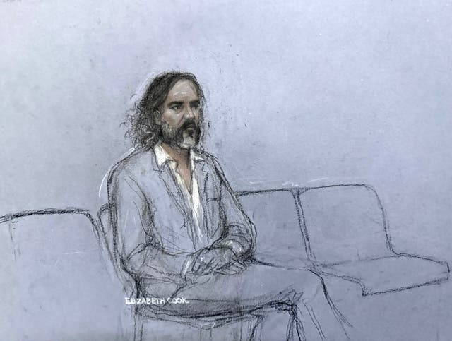 Brand listening to the prosecutor’s opening address in court
