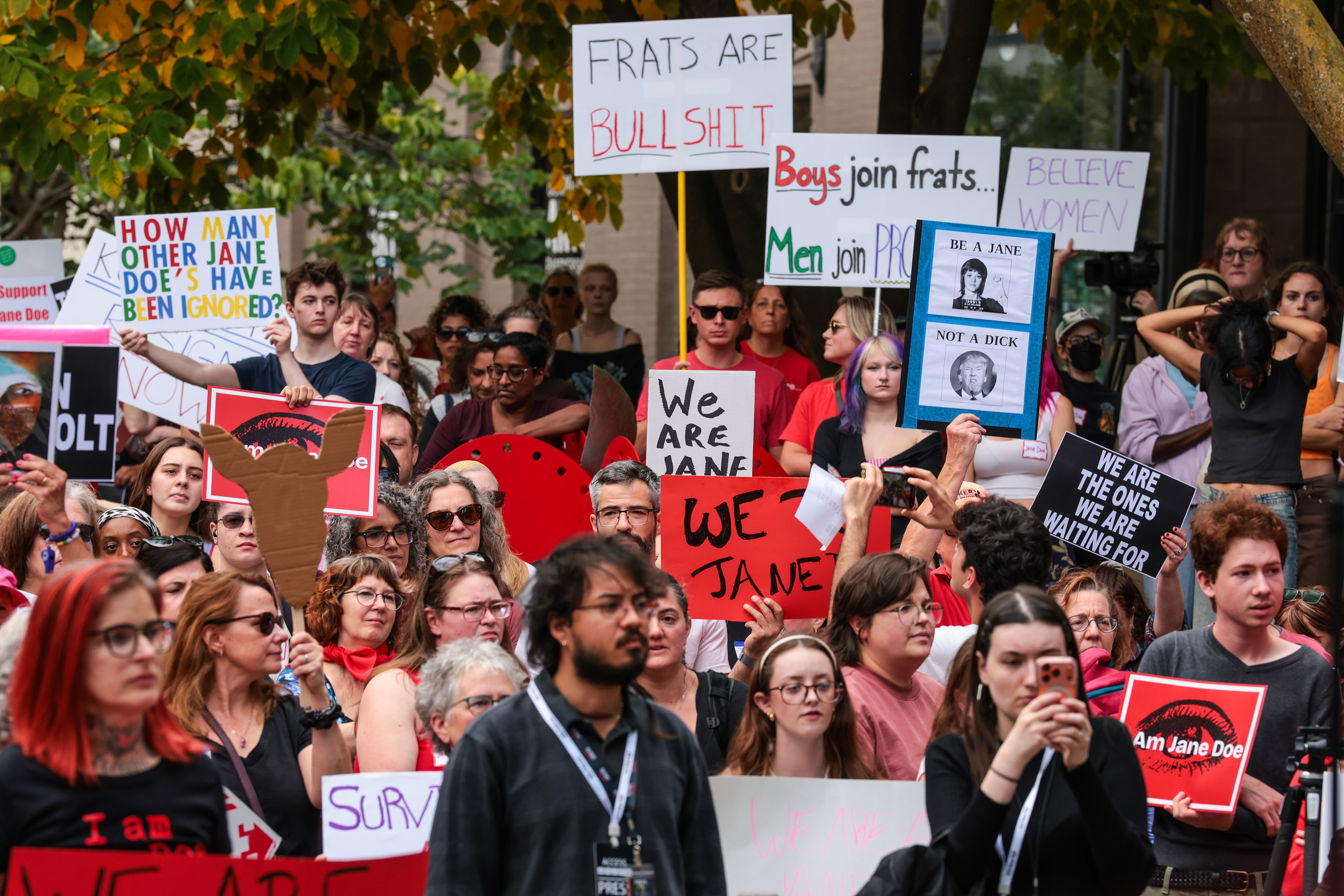 Protesters listen to speakers at a rally in support of a former Cornell University student known as Jane Doe at the Ithaca Commons on October 13
