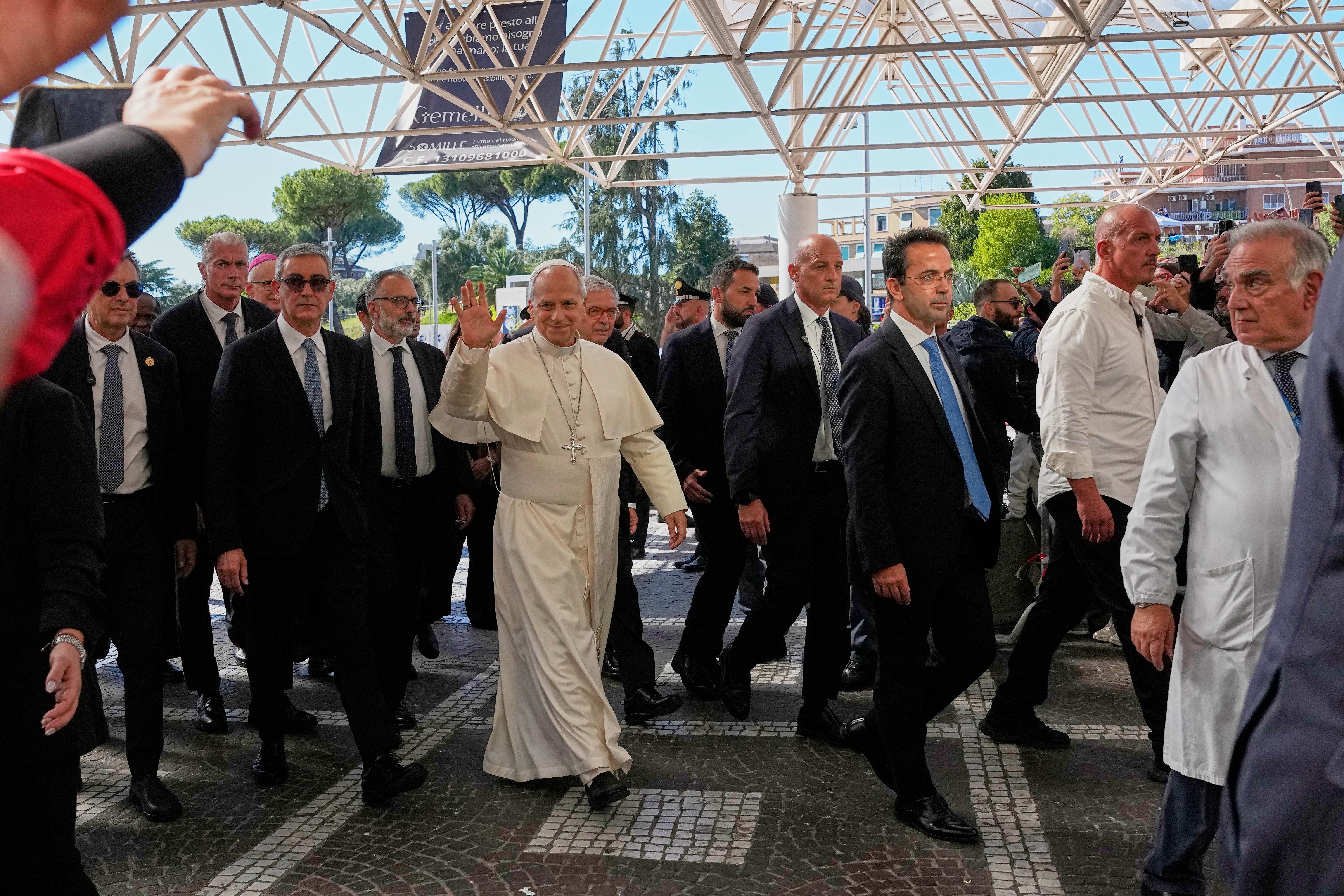 Photos show Pope Leo XIV at hospital and supporters praying as he undergoes cancer surgery