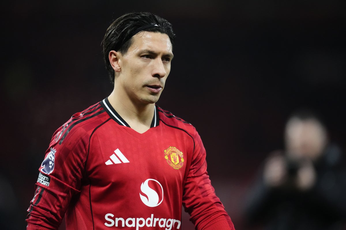 Lisandro Martinez challenging for the ball in a Manchester United shirt during a competitive match.