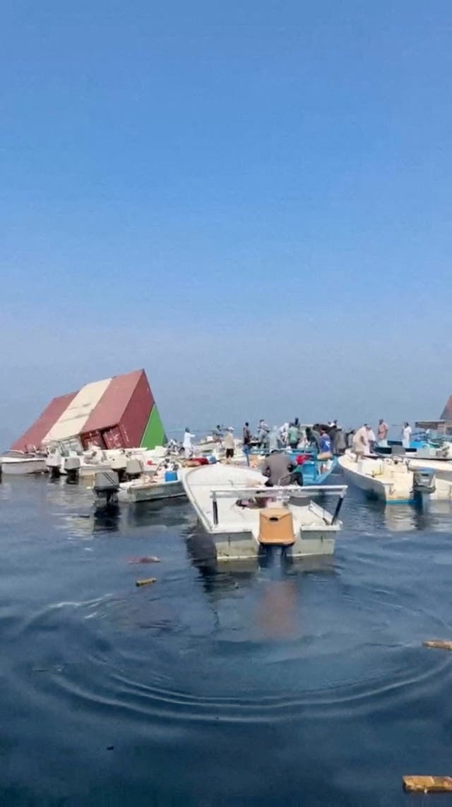 Containers float in the water after a vessel sank near the Strait of Hormuz off the coast of Oman, in this still image obtained from a social media video, released October 14, 2026.