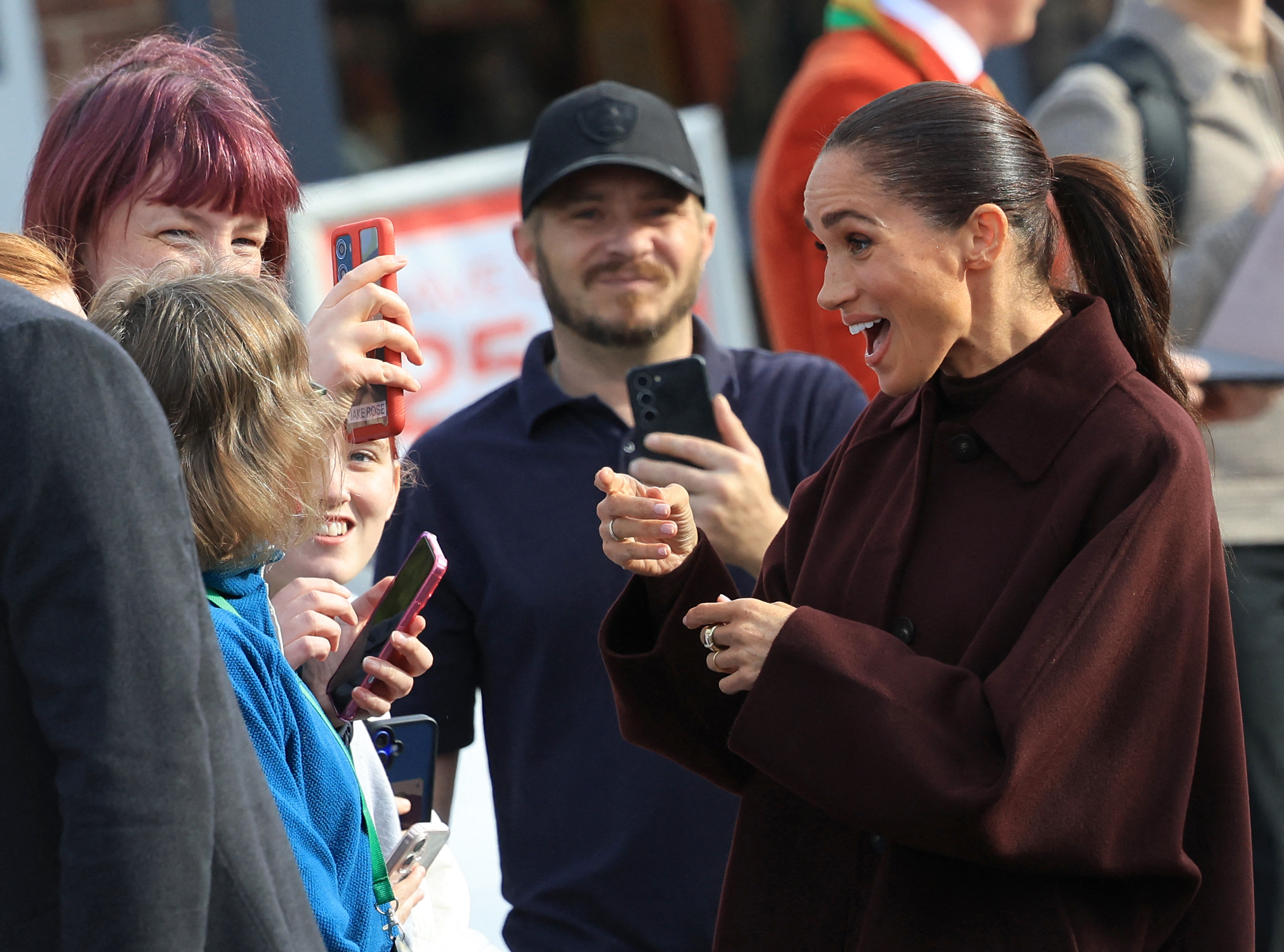 Meghan reacts as she greets well-wishers