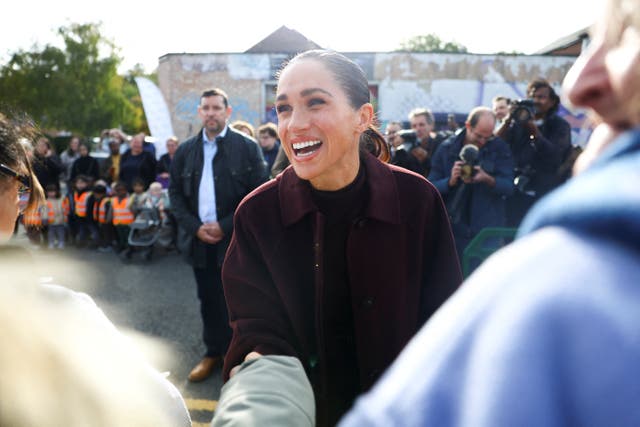 Meghan pictured smiling with fans in Nottingham