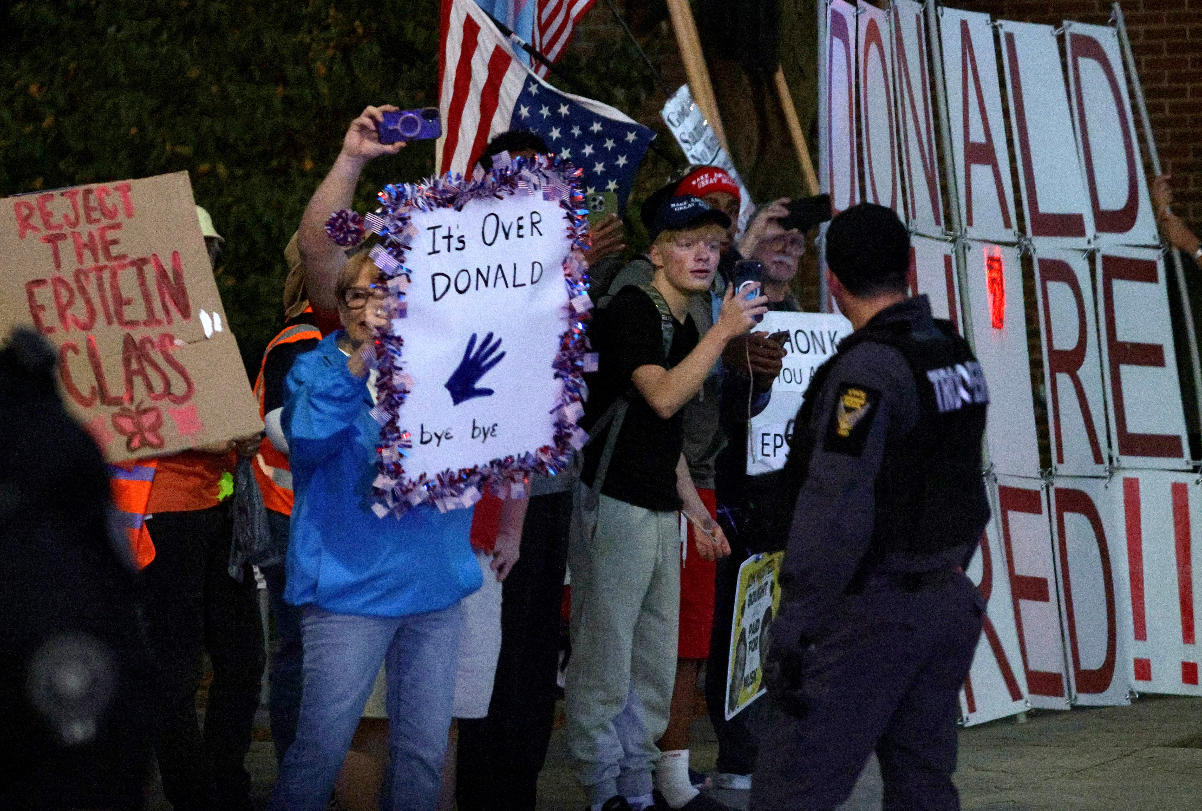 Protesters gather outside of the Covelli Centre as the motorcade of President Donald Trump passes before the start of a campaign rally on October 12, 2026 in Youngstown