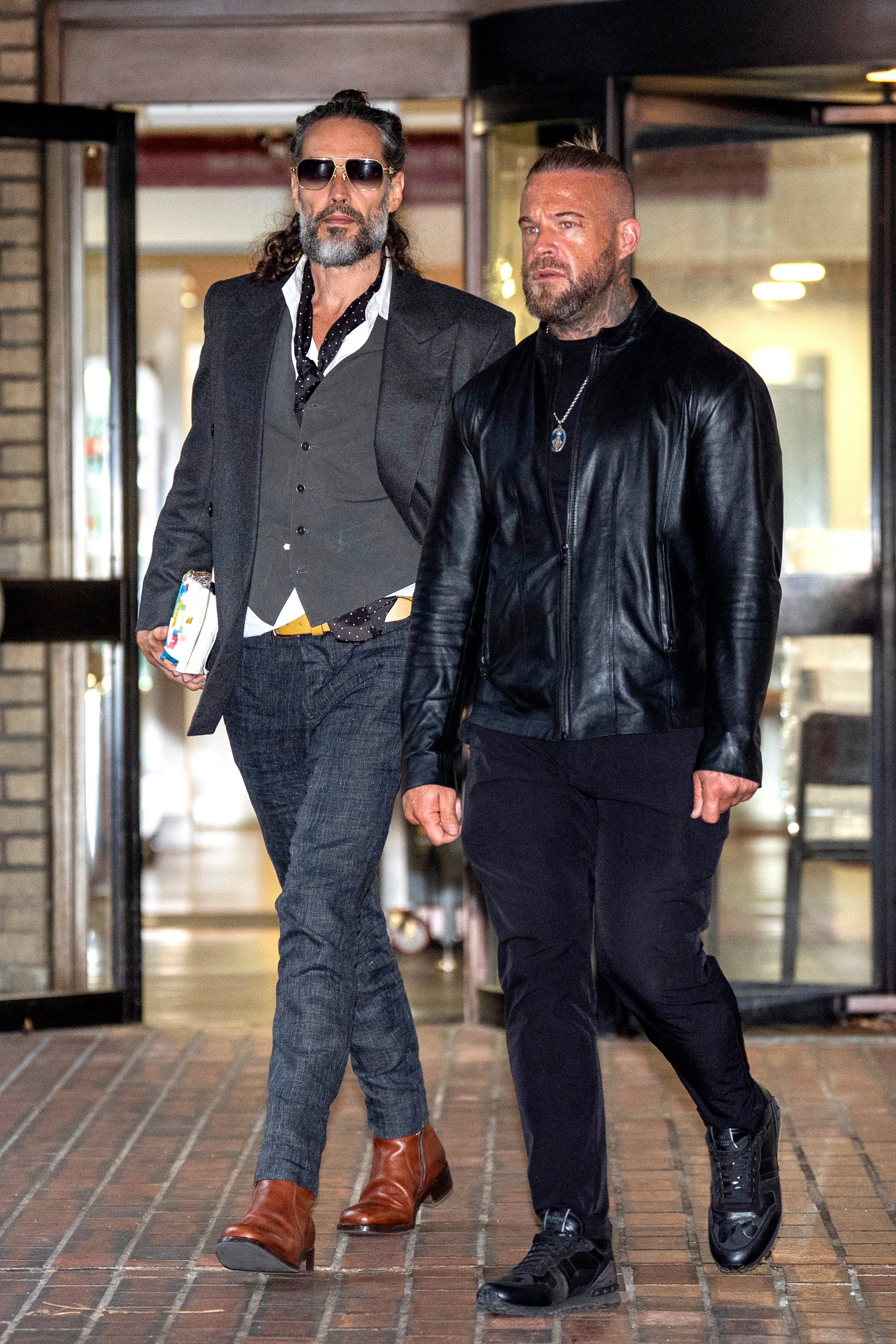 Brand leaving court with his bodyguard on Thursday