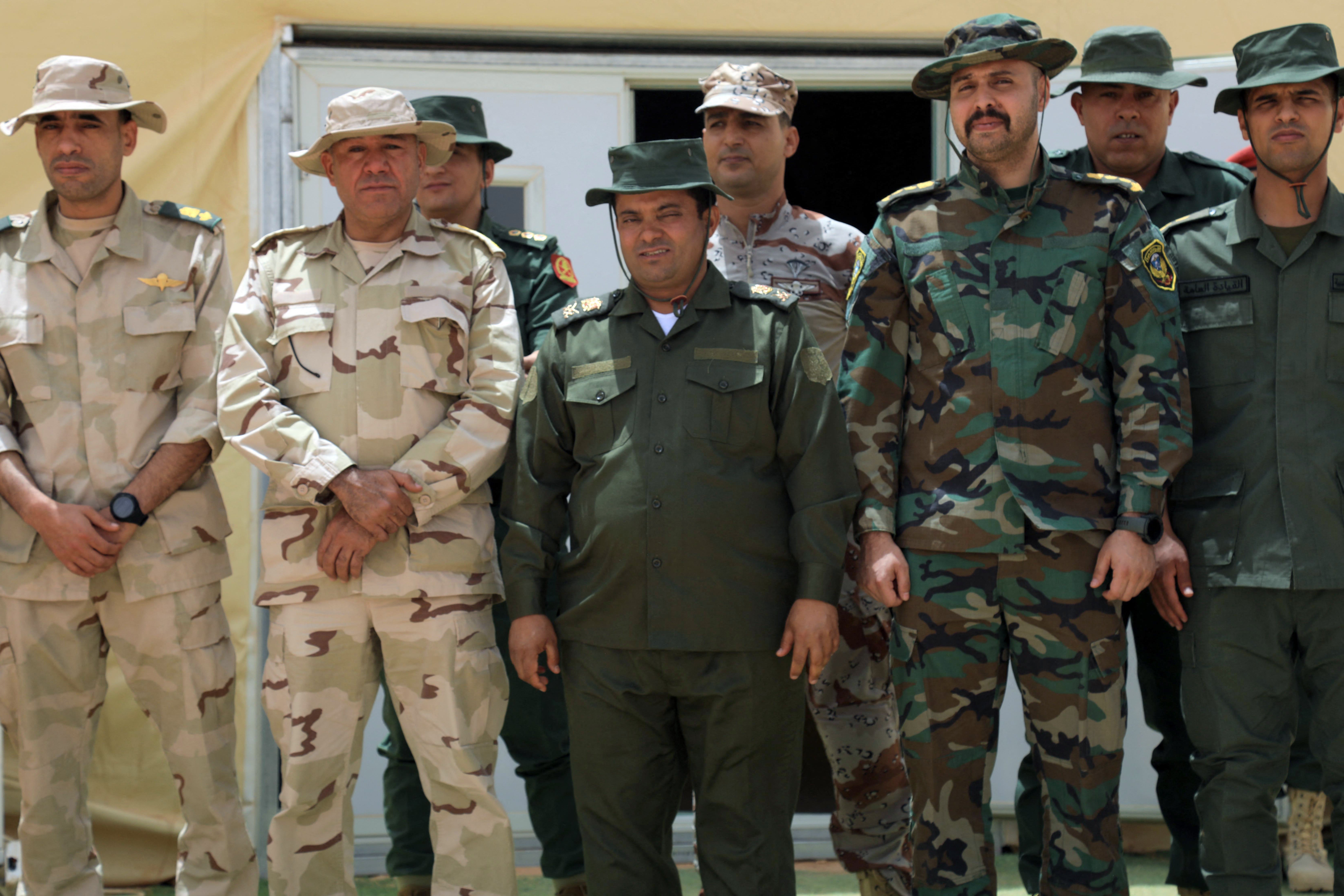 Libyan Major General Omer Amraji (C) poses with his fellow officers for a photograph during the "Dara' al-Karama 2" military exercises, conducted by the Libyan National Army (LNA), under the command of Field Marshal Khalifa Haftar