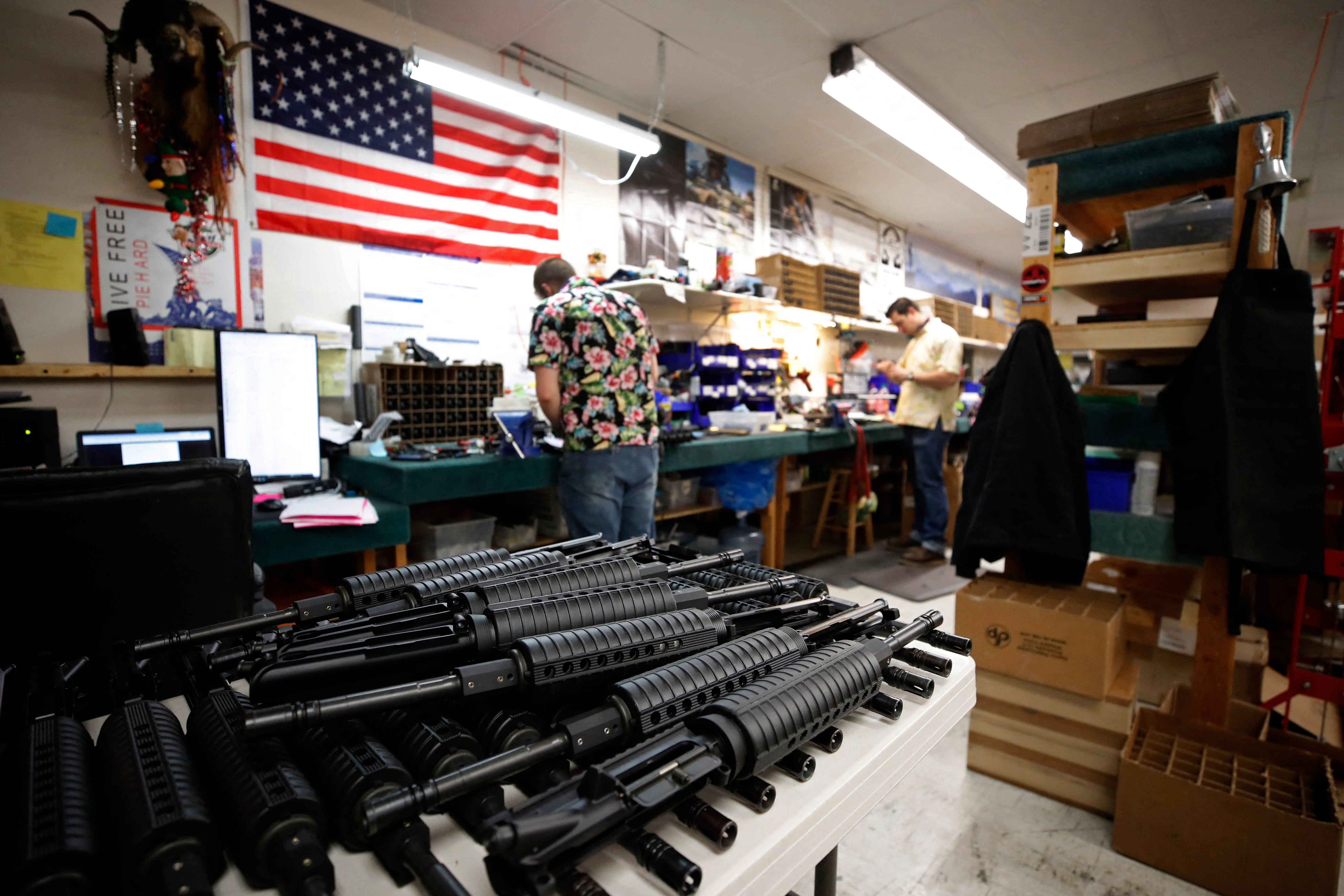 AR-15 style rifle barrels sit on a cart as workers assembles the gun at Davidson Defense in Orem, Utah on February 4, 2021