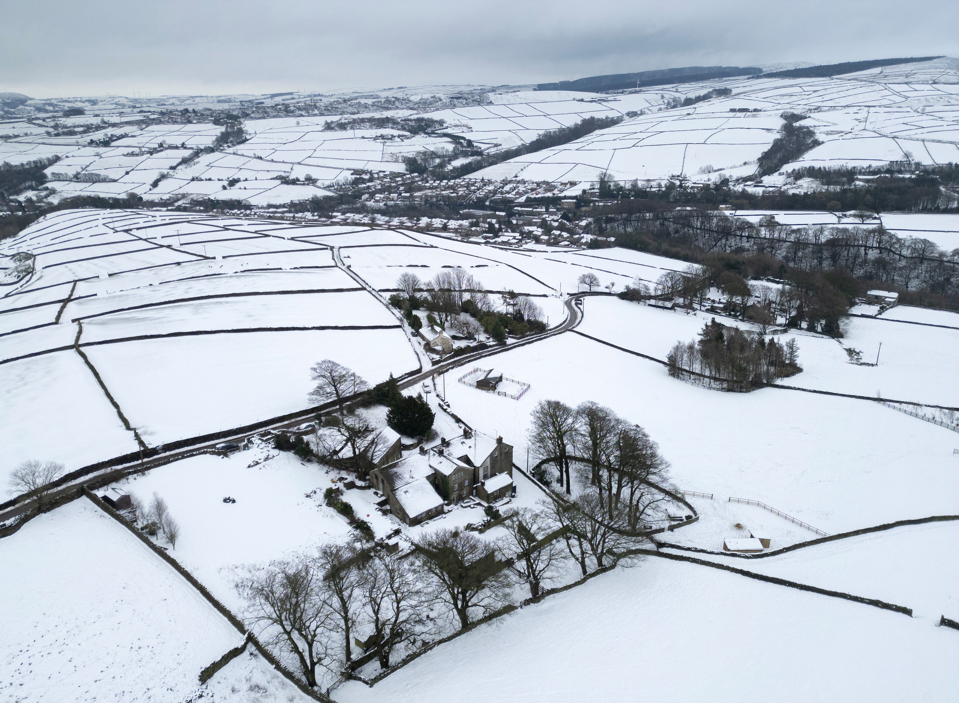 Snow-covered fields and properties following overnight snowfall, near the town of Holmfirth, West Yorkshire, northern England on January 9, 2026