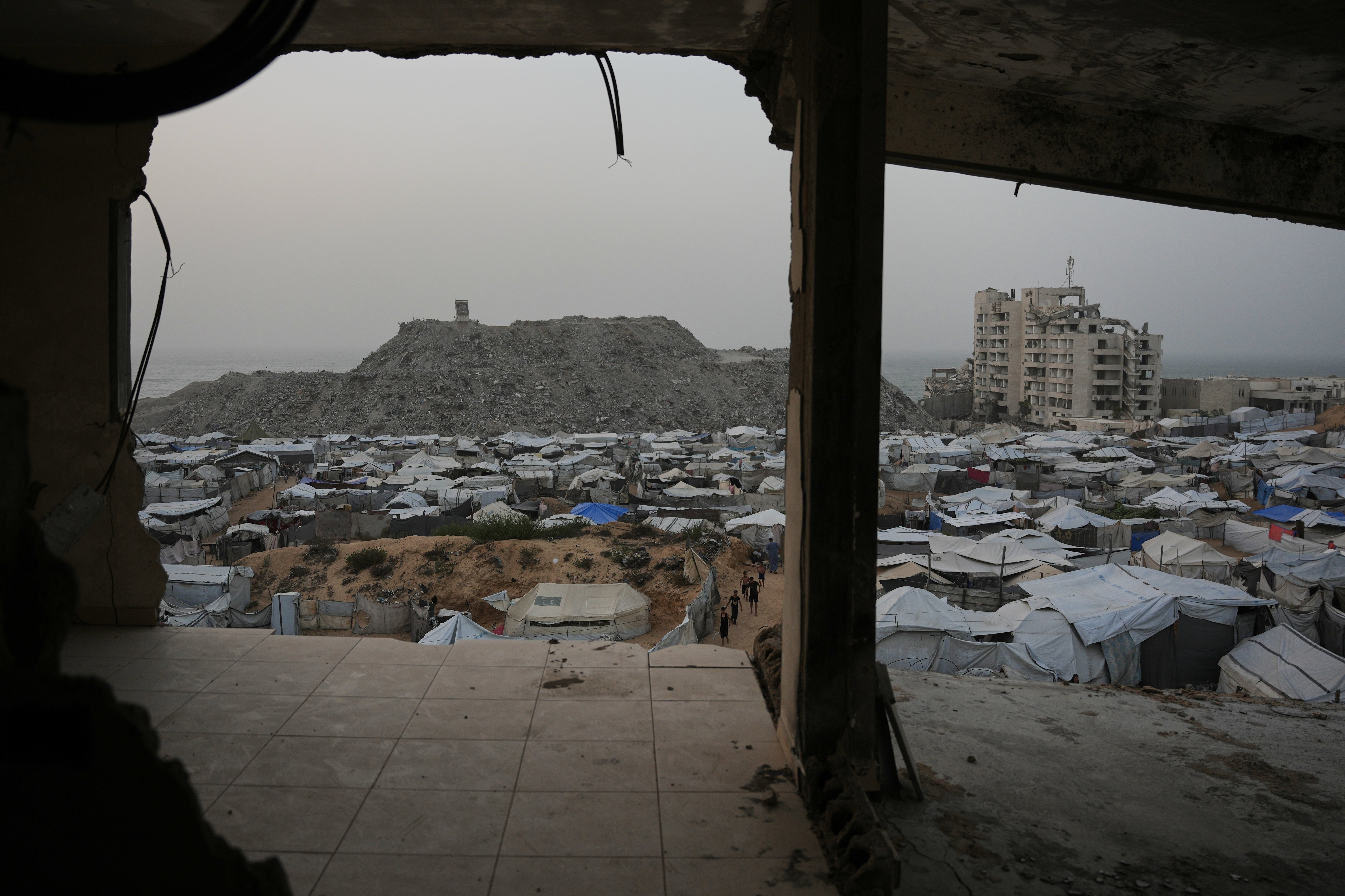 Palestinians walk among tents at a tent camp for displaced people in Gaza City, Friday, Oct. 16, 2026. (AP Photo/Abdel Kareem Hana)