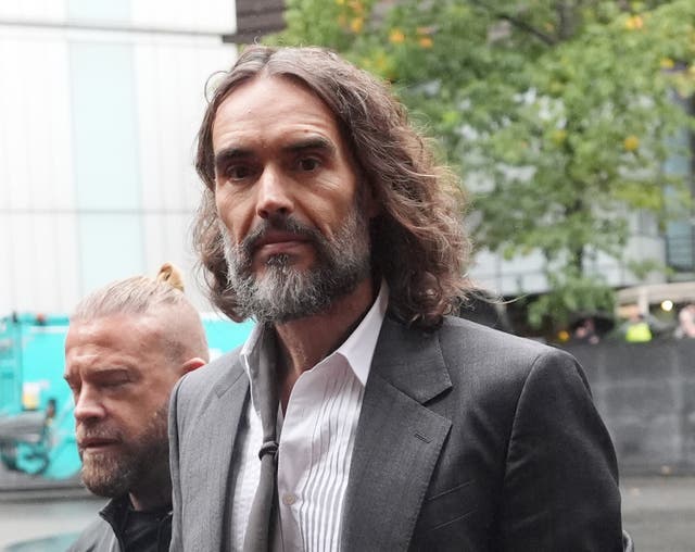 Russell Brand arriving at Southwark Crown Court with his close protection officer