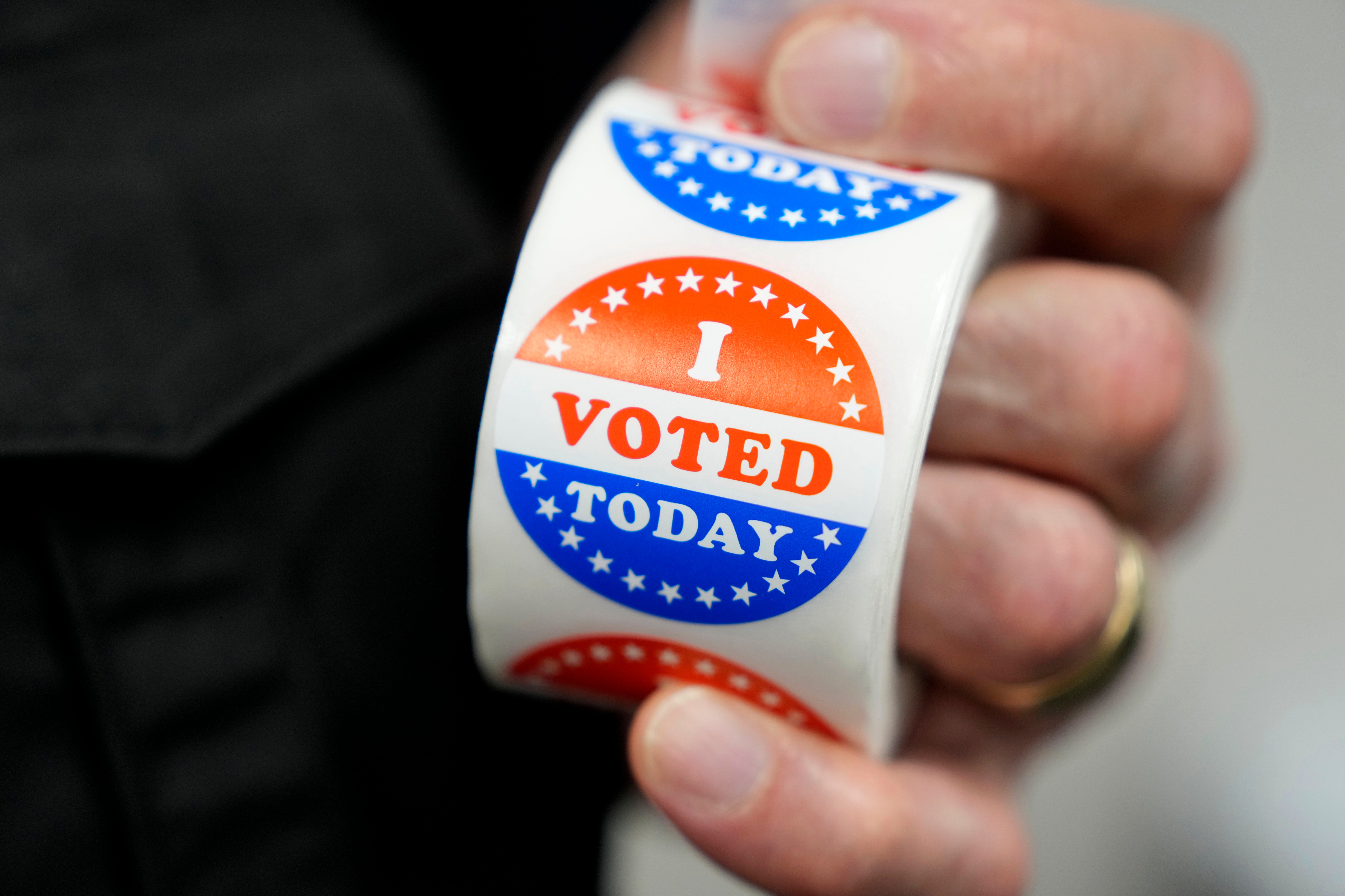 A worker holds I Voted Today stickers during early voting at the Polk County Election Office in Iowa