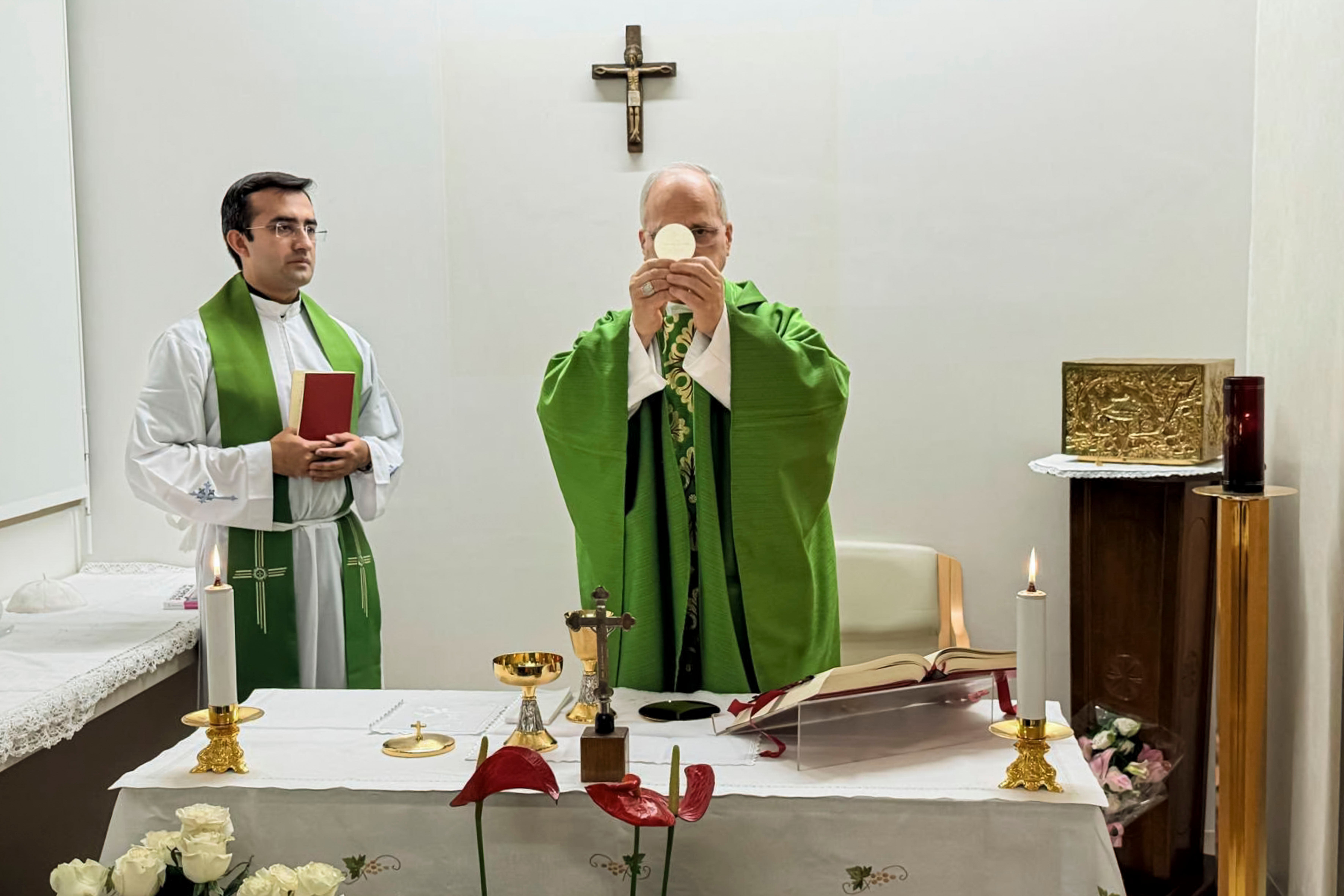 Pope Leo XIV, flanked by his personal secretary, Monsignor Edgard Iván Rimaycuna Inga, left, celebrates Mass at the Agostino Gemelli Polyclinic in Rome, where he is recovering after having cancer removed from his right lung