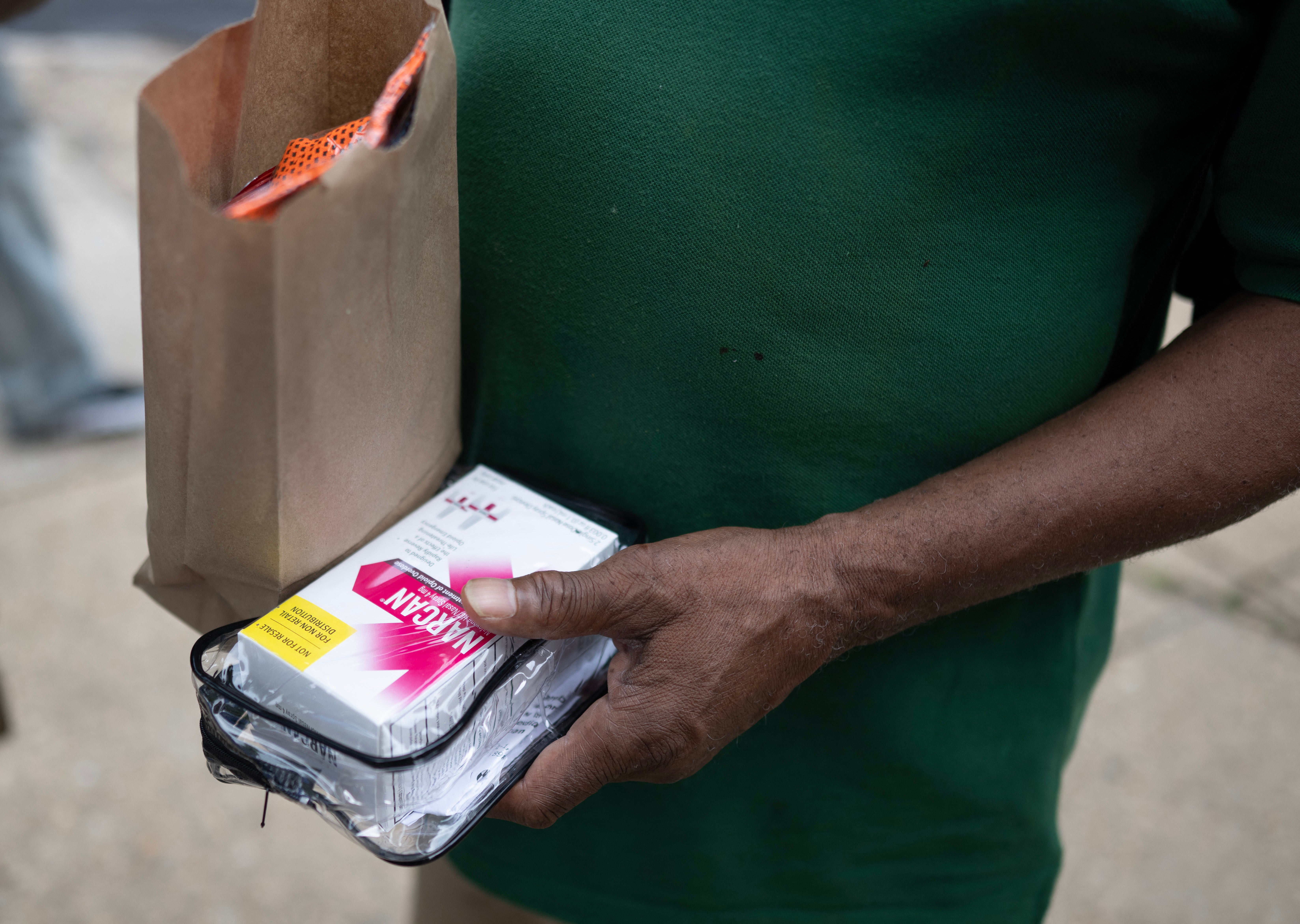 A man looks at a box of Narcan given to him by members of Catholic Charaties in Baltimore, Maryland on June 10, 2025