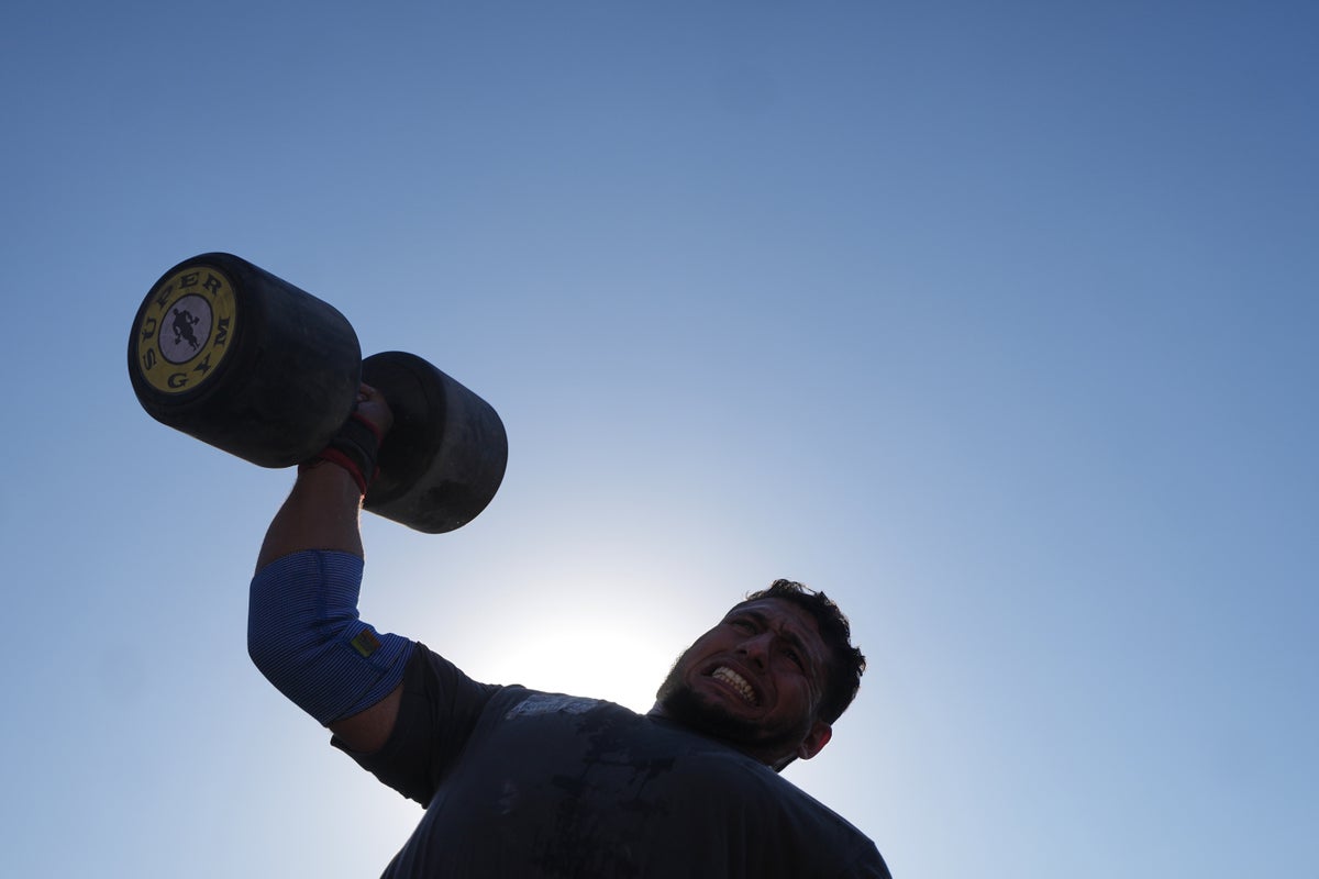 Burly men in Gaza pull trucks and flip tires in competition of strength