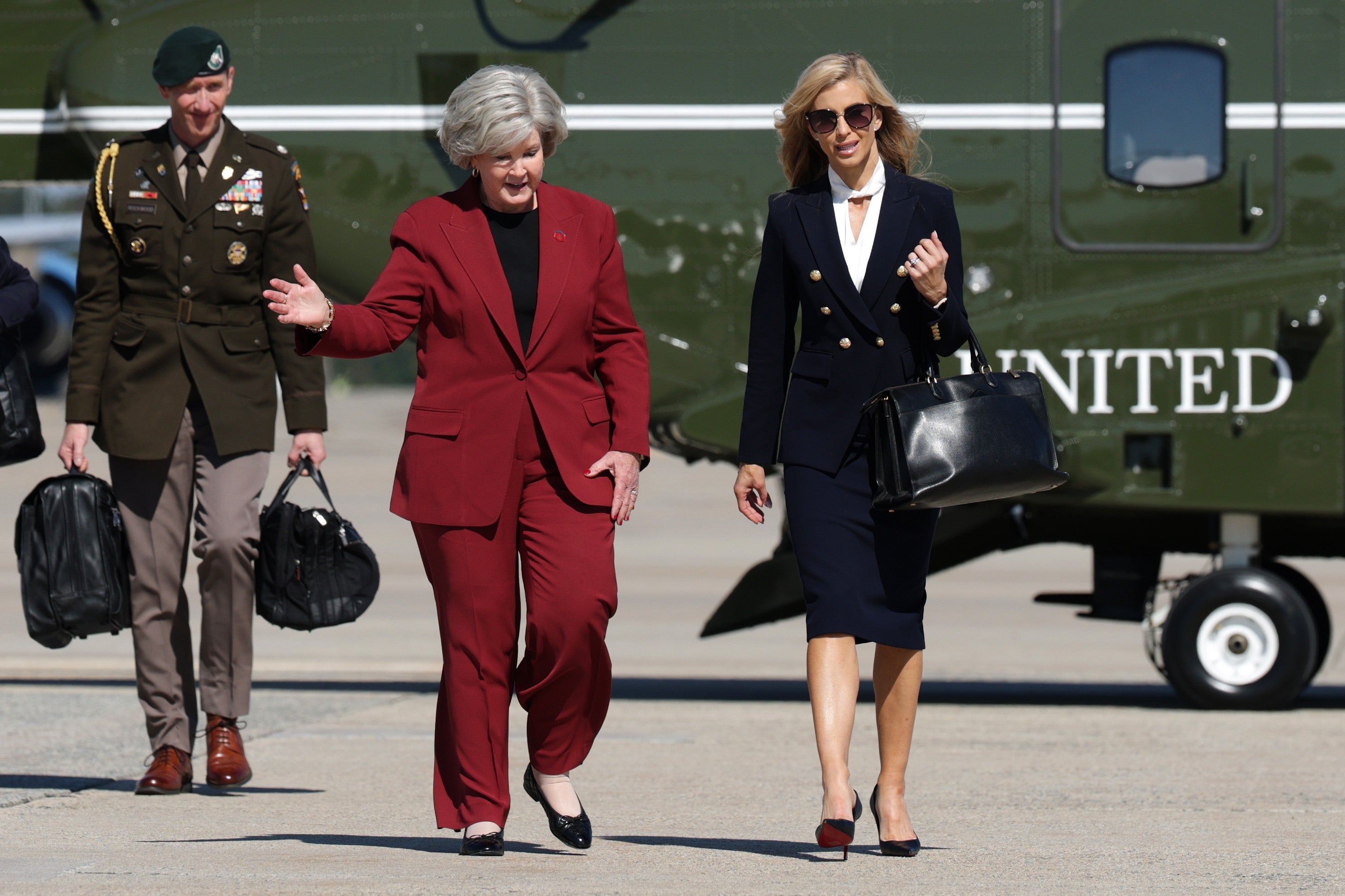After the president went around his chief of staff Wiles (in red) to hire Zacharia (walking with Wiles), an unqualified TV personality as his top spokesperson, his choice was disassembled on his favorite TV channel, Fox News, within 72 hours