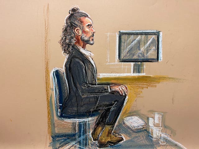 Russell Brand sat bolt upright in his chair in the dock of Southwark Crown Court