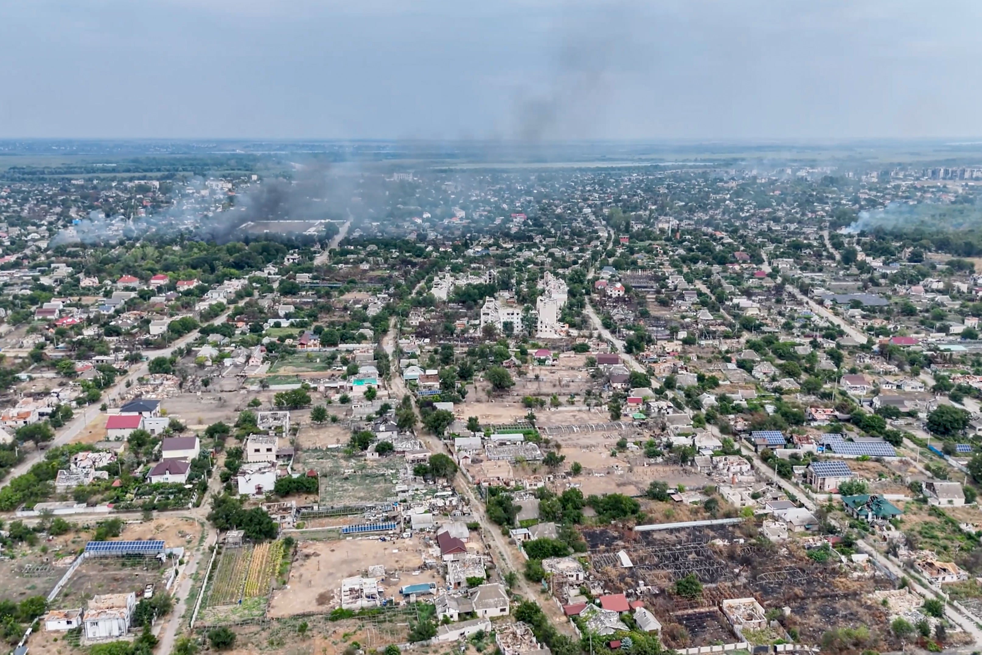 Smoke rises from a residential neighborhood in the Russian-occupied city of Oleshky in the Kherson region of Ukraine