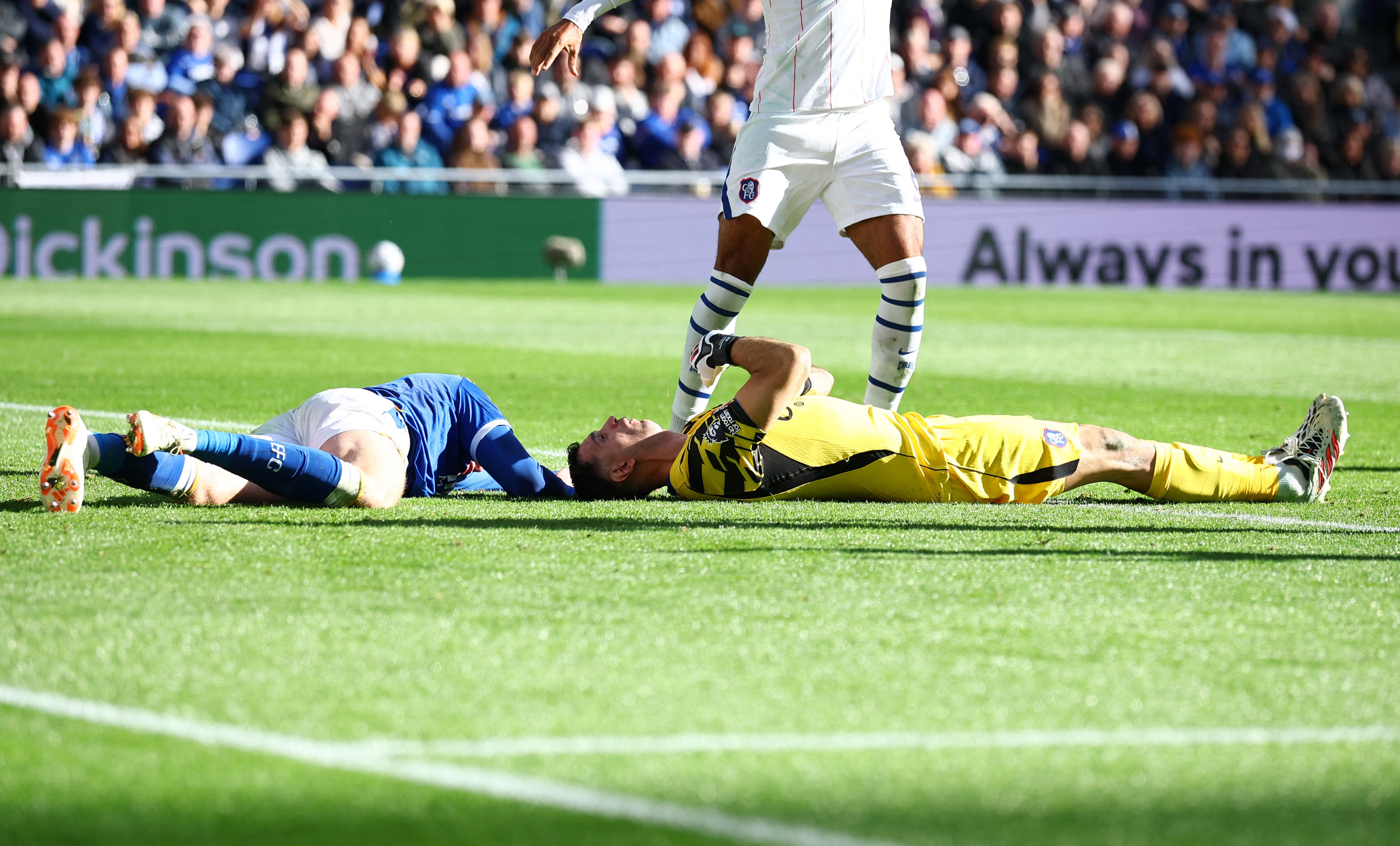 Martinez and Everton's Branthwaite on the ground after the collision