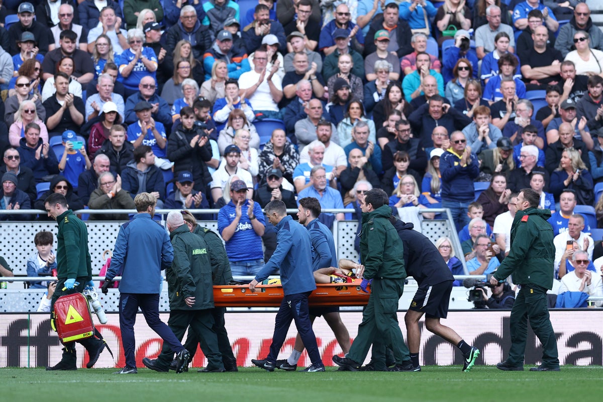 Emi Martinez stretched off pitch after clashing heads with Everton star