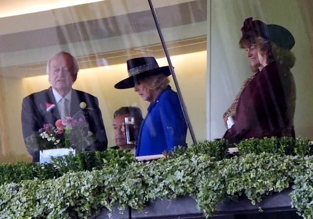 Queen Camilla holds a drink in the Royal Box at Ascot Racecourse