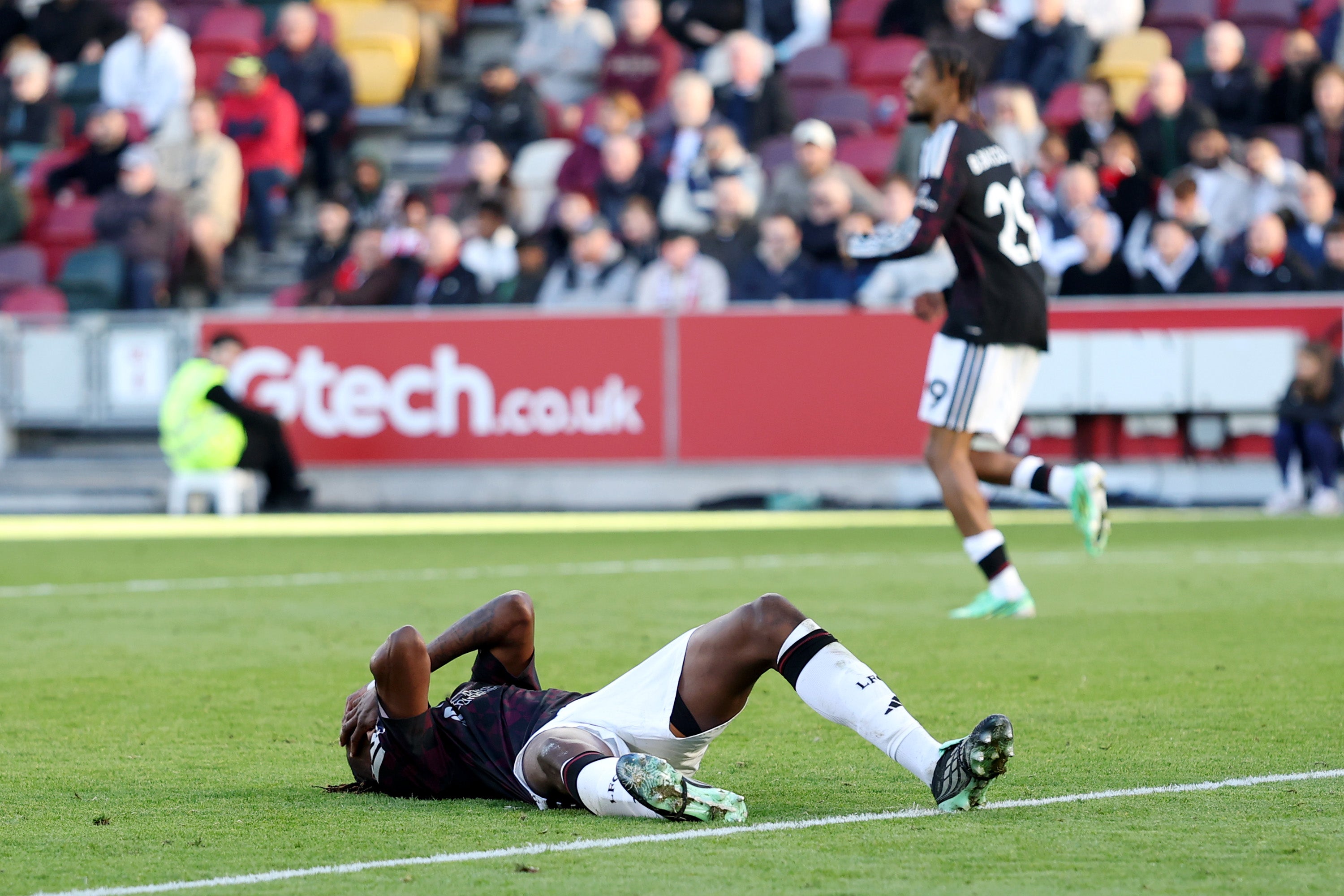 Jeremy Jacquet of Liverpool reacts after clashing with Yehor Yarmolyuk of Brentford