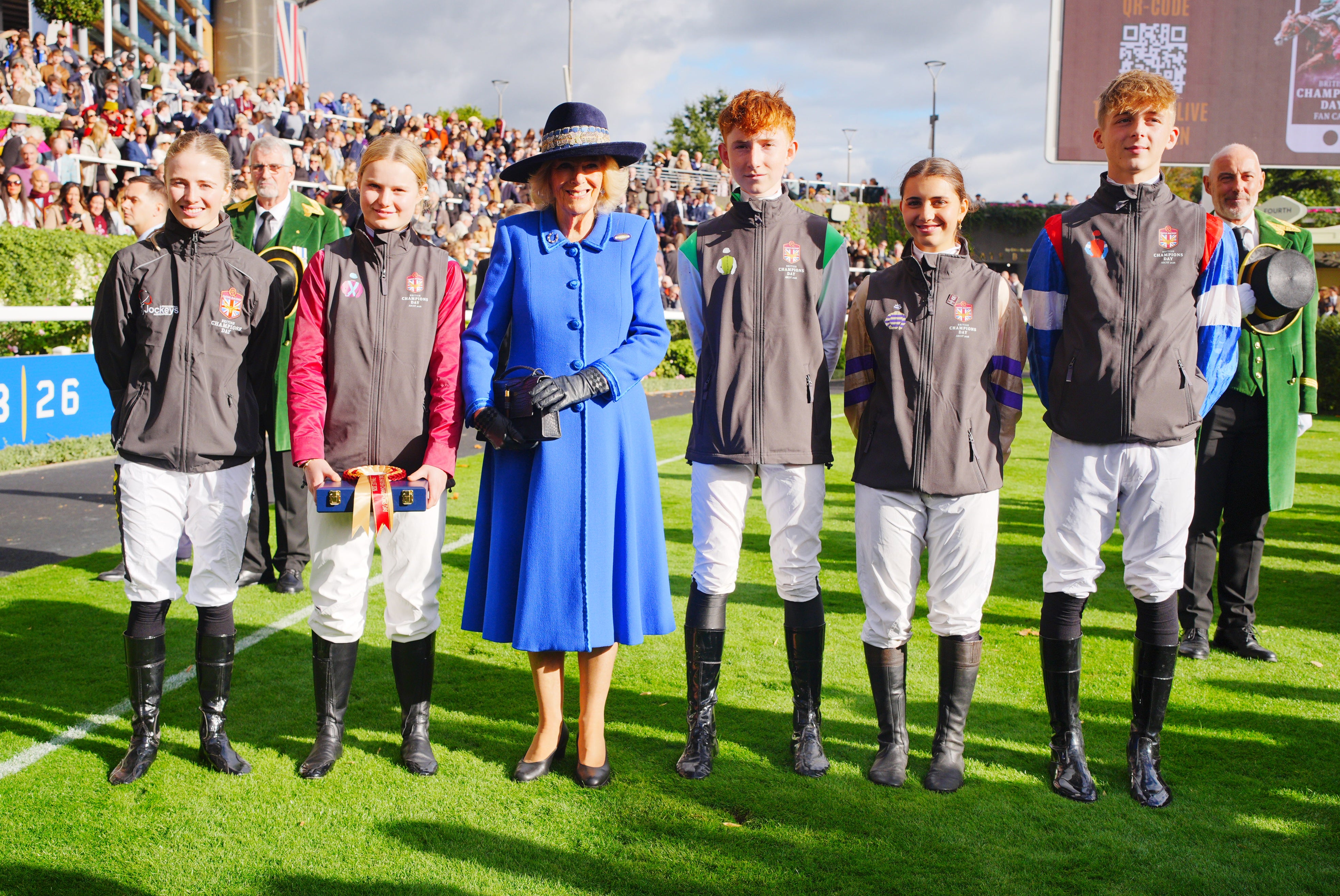 From left, Saffie Osborne, Camilla Froggatt, Queen Camilla, Oliver Virgos, Lola Moore and Jack Pipe at the British Champions Day