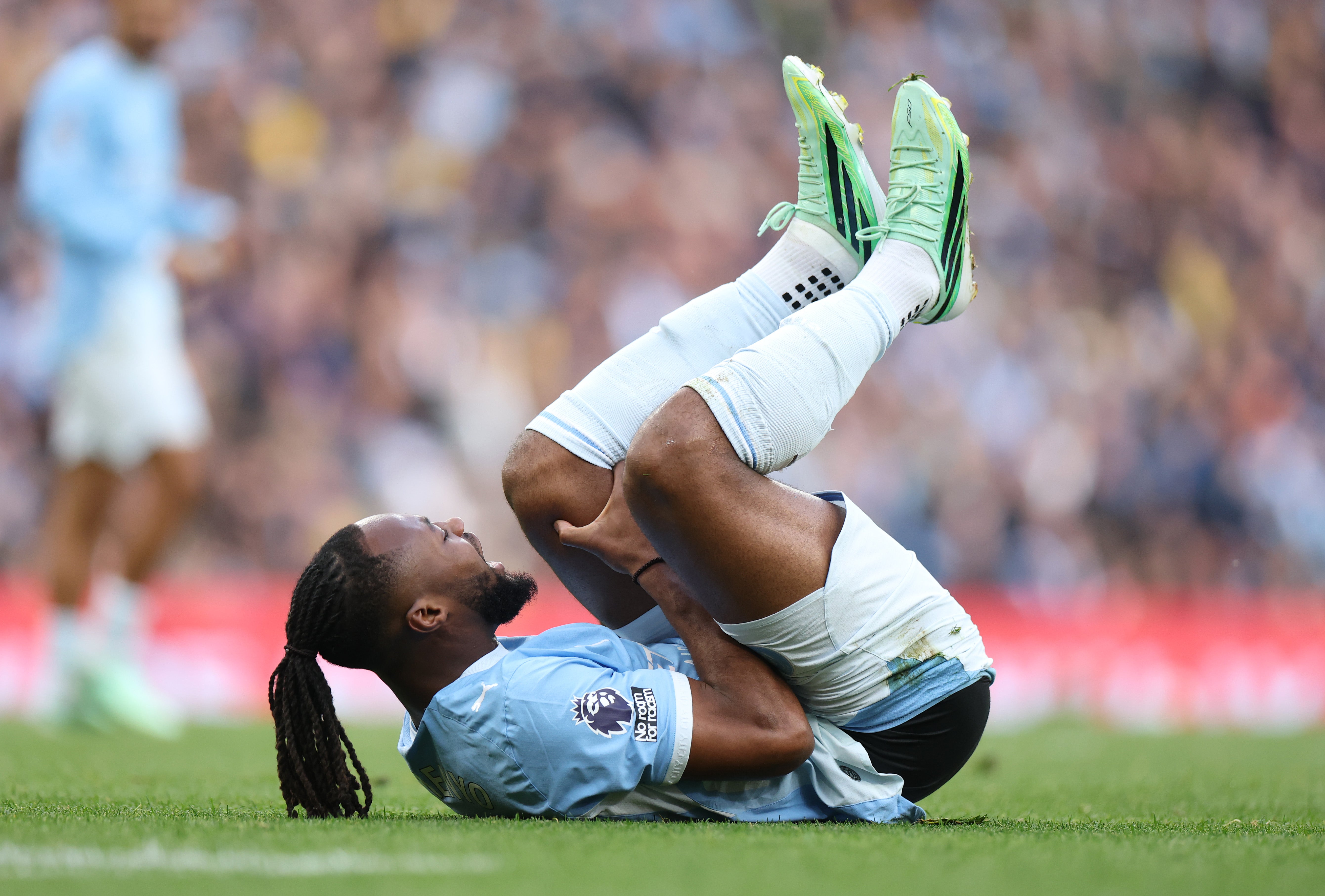 Antoine Semenyo of Manchester City holds his leg after picking up an injury