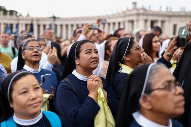 Faithful gather in St. Peter's Square as Pope Leo leads the Angelus prayer from a window of the Apostolic Palace, following his discharge from hospital after surgery for lung cancer, at the Vatican